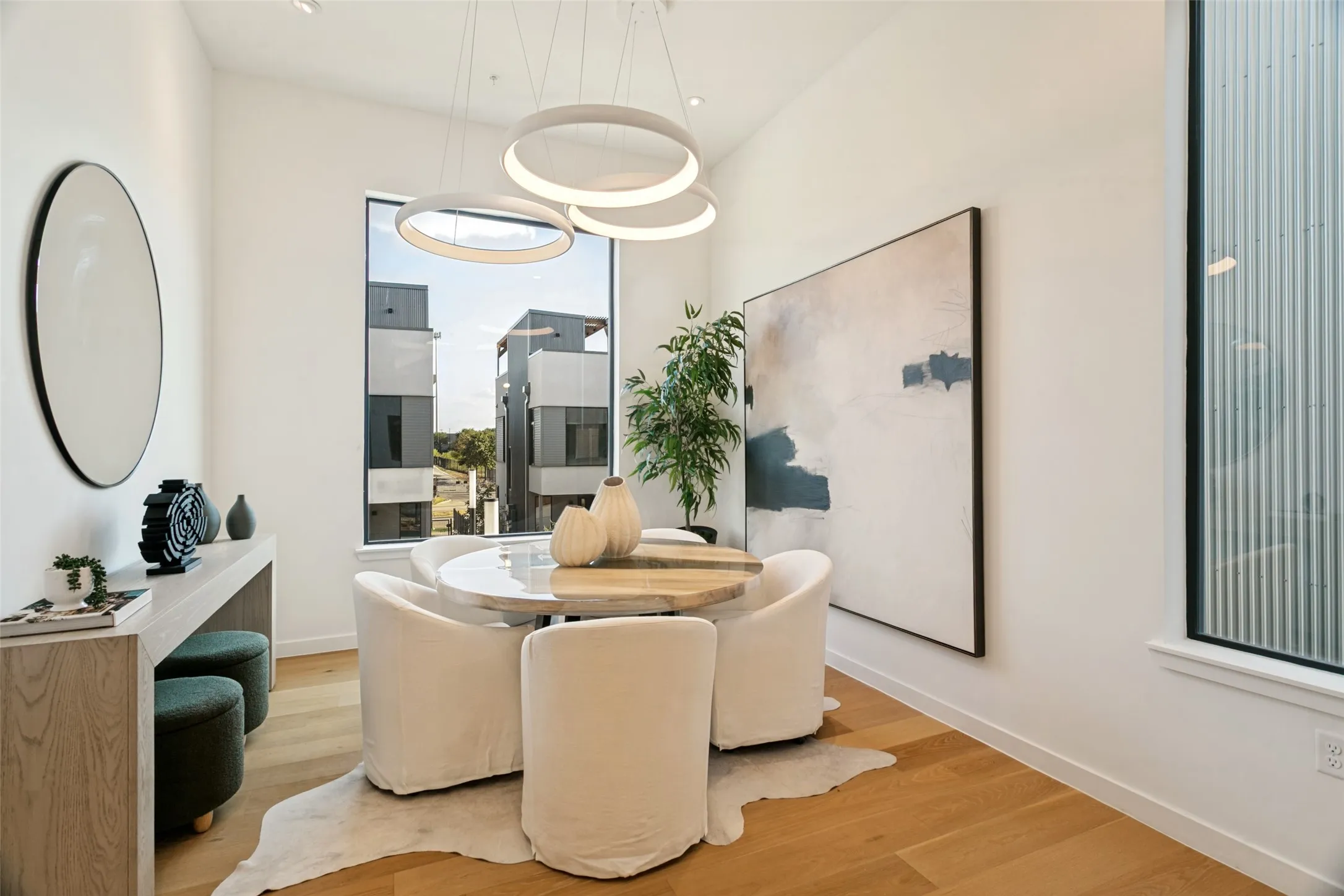 Hardwood flooring, large windows, contemporary light fixtures, and high ceilings