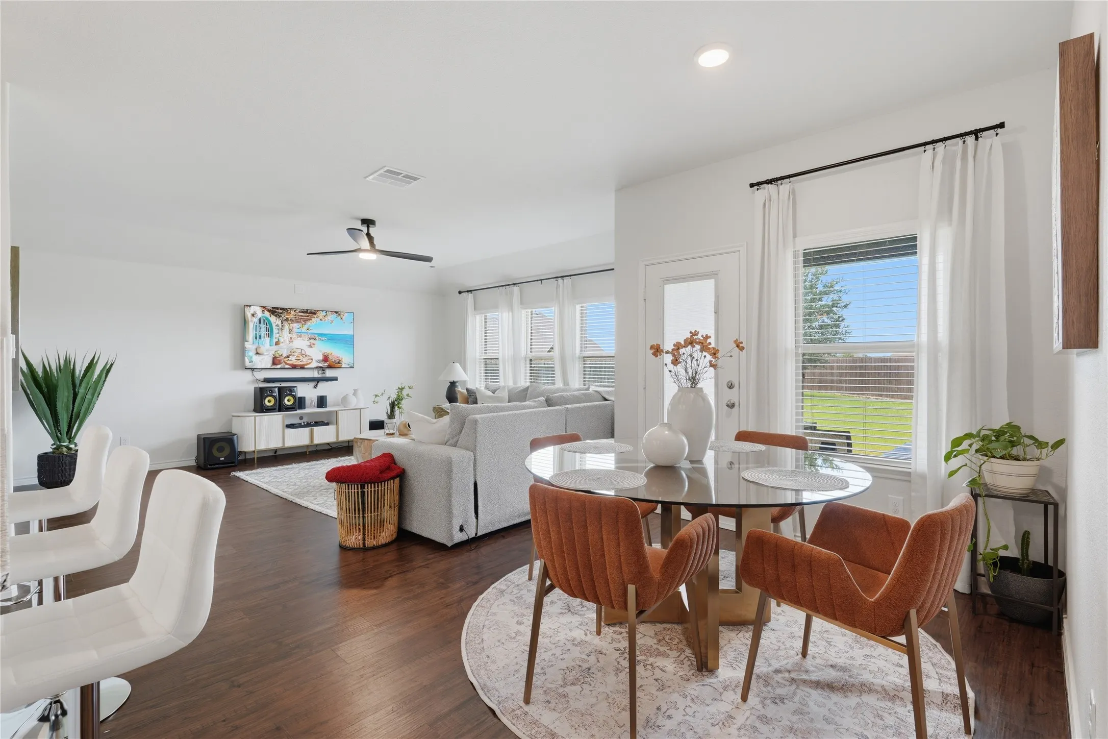 Open-concept living area featuring dark wood-finish flooring, recessed lighting, and a modern ceiling fan