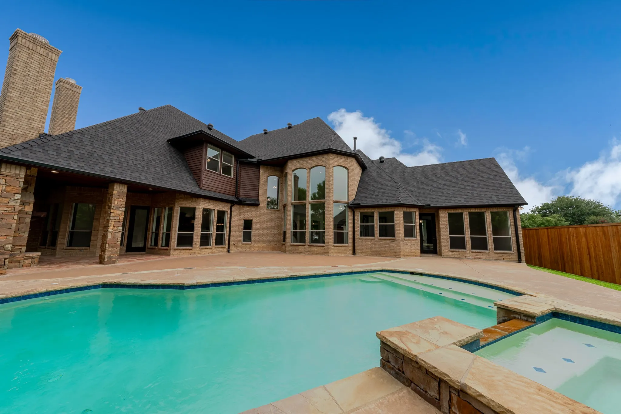 Expansive patio with an integrated swimming pool and spa