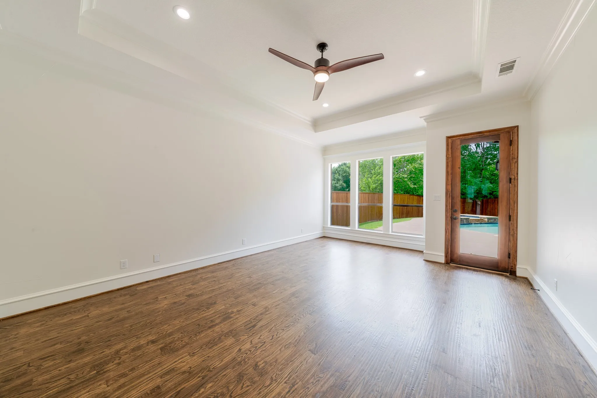 Spacious Primary room with wood-finish flooring, recessed lighting, and a ceiling fan