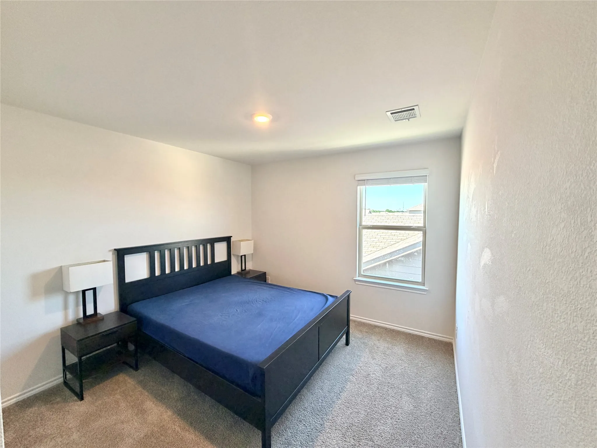 Carpeted room featuring a single window with blinds and white trim