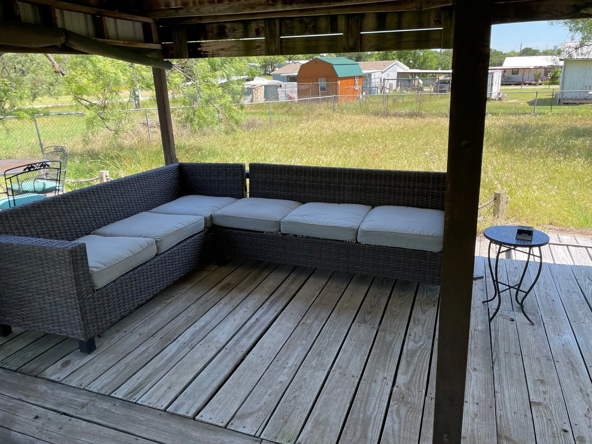 Covered wood deck with visible wood beams and a metal roof