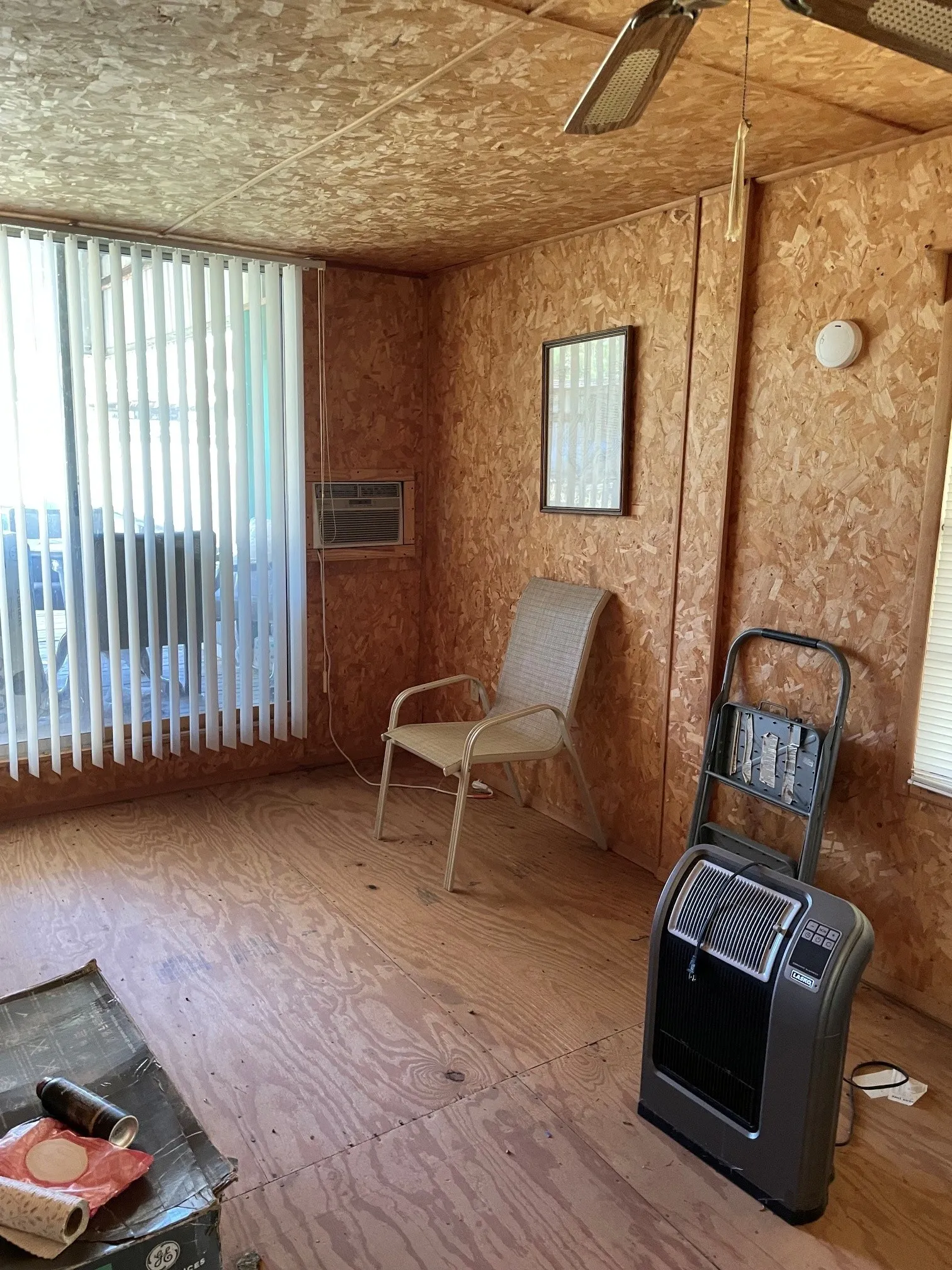 Room featuring wood-finish paneling on walls and ceiling