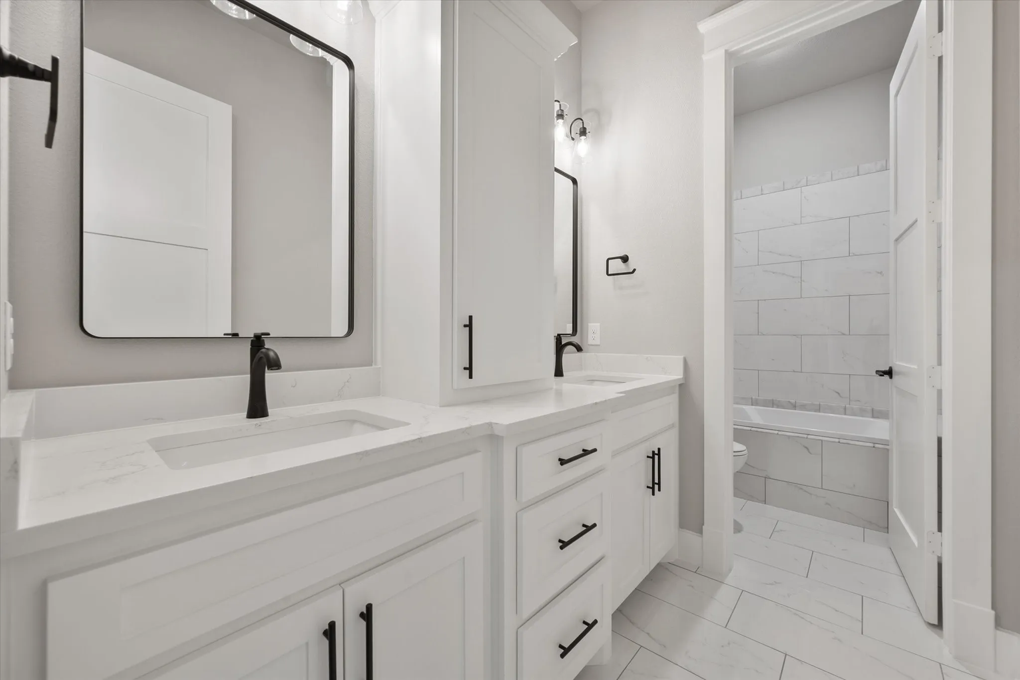 Dual vanity with integrated sinks and white countertops