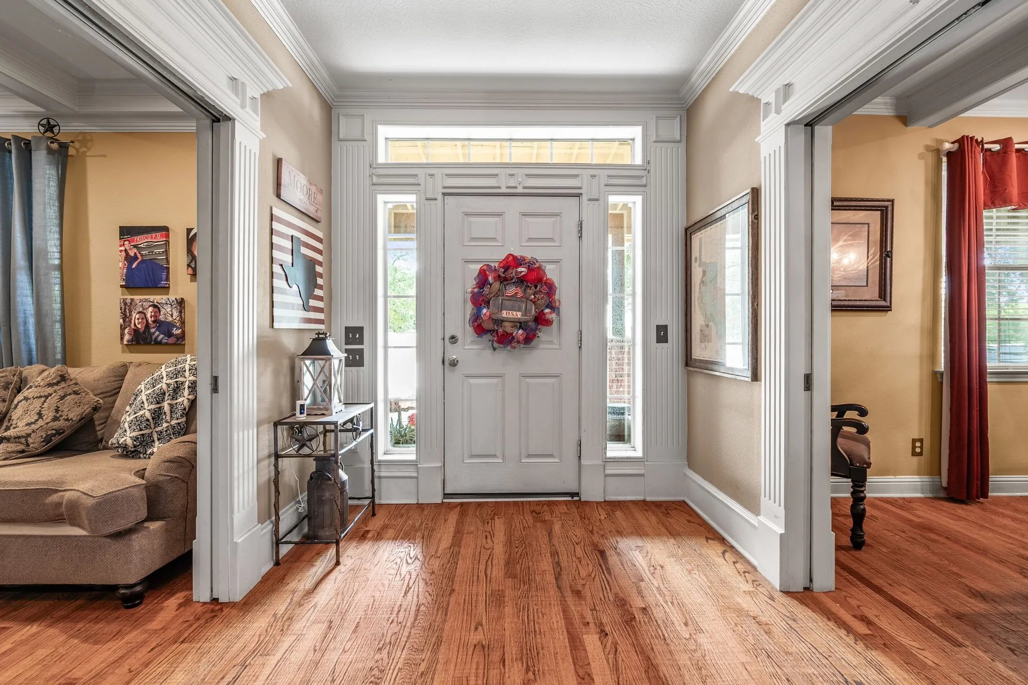 Grand entryway featuring a paneled door with sidelights and a transom window