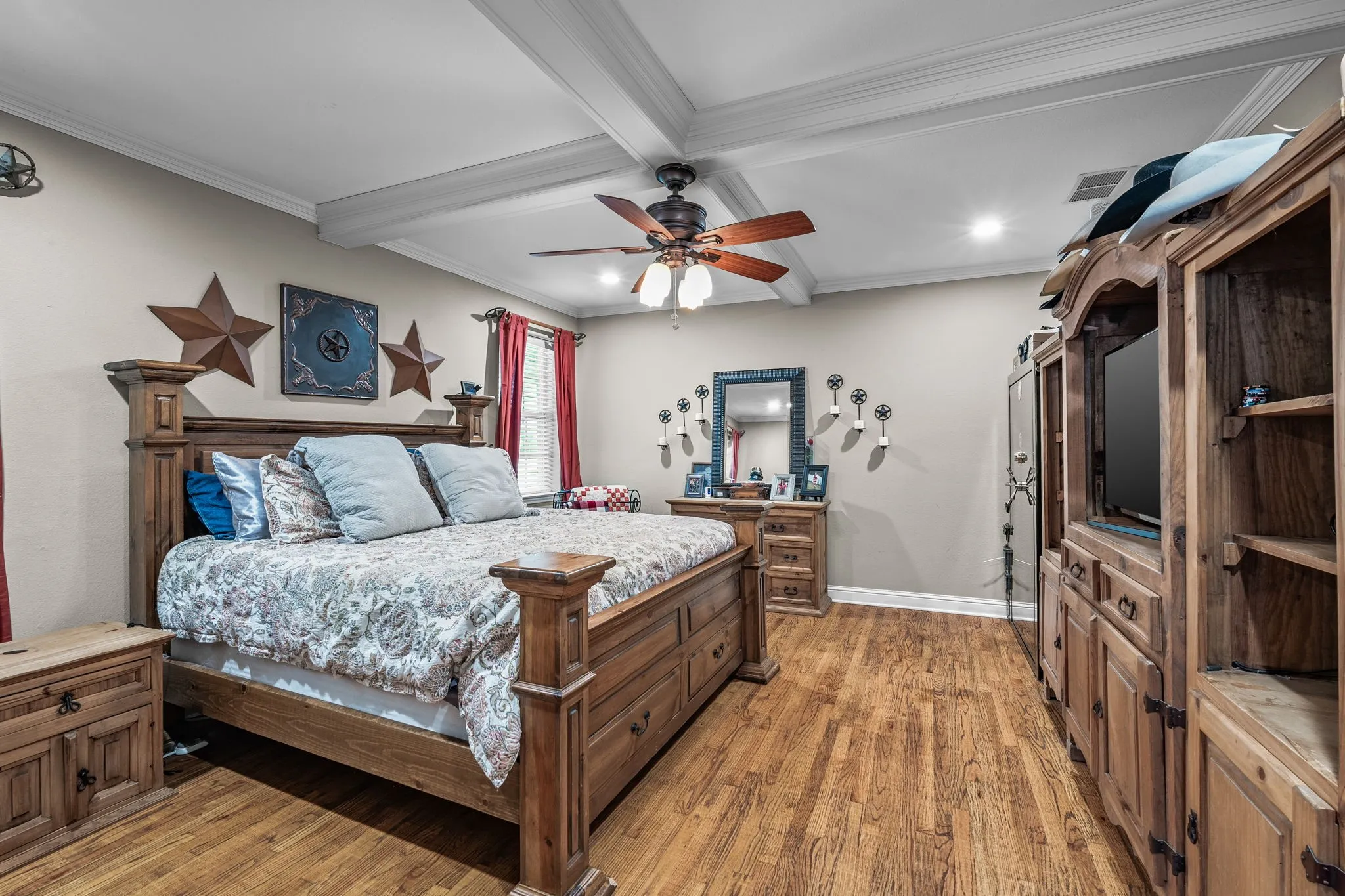 Spacious room featuring wood-finish flooring, a coffered ceiling with a ceiling fan, and recessed lighting