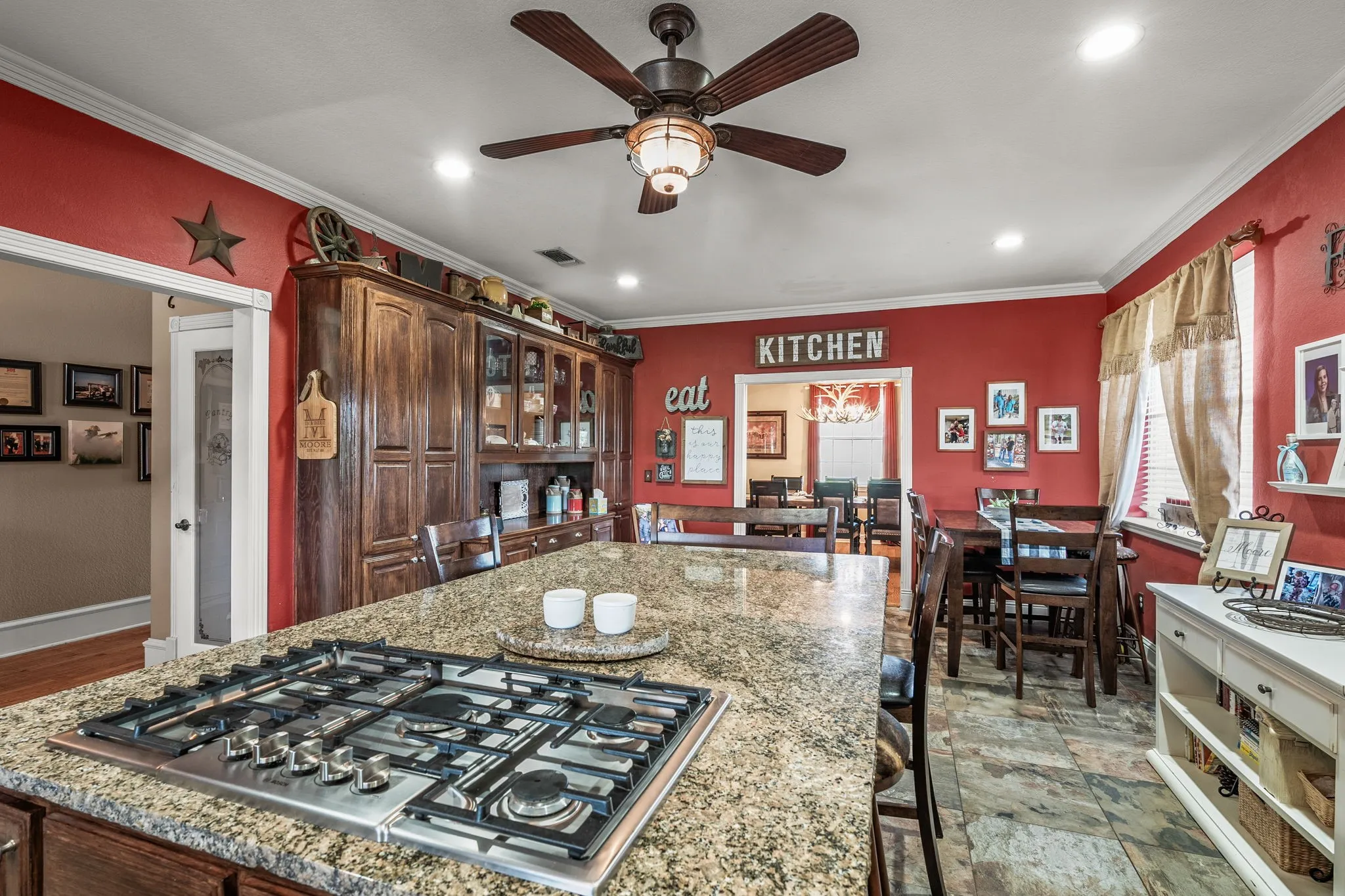 Kitchen featuring a large island with an integrated gas cooktop and granite countertops