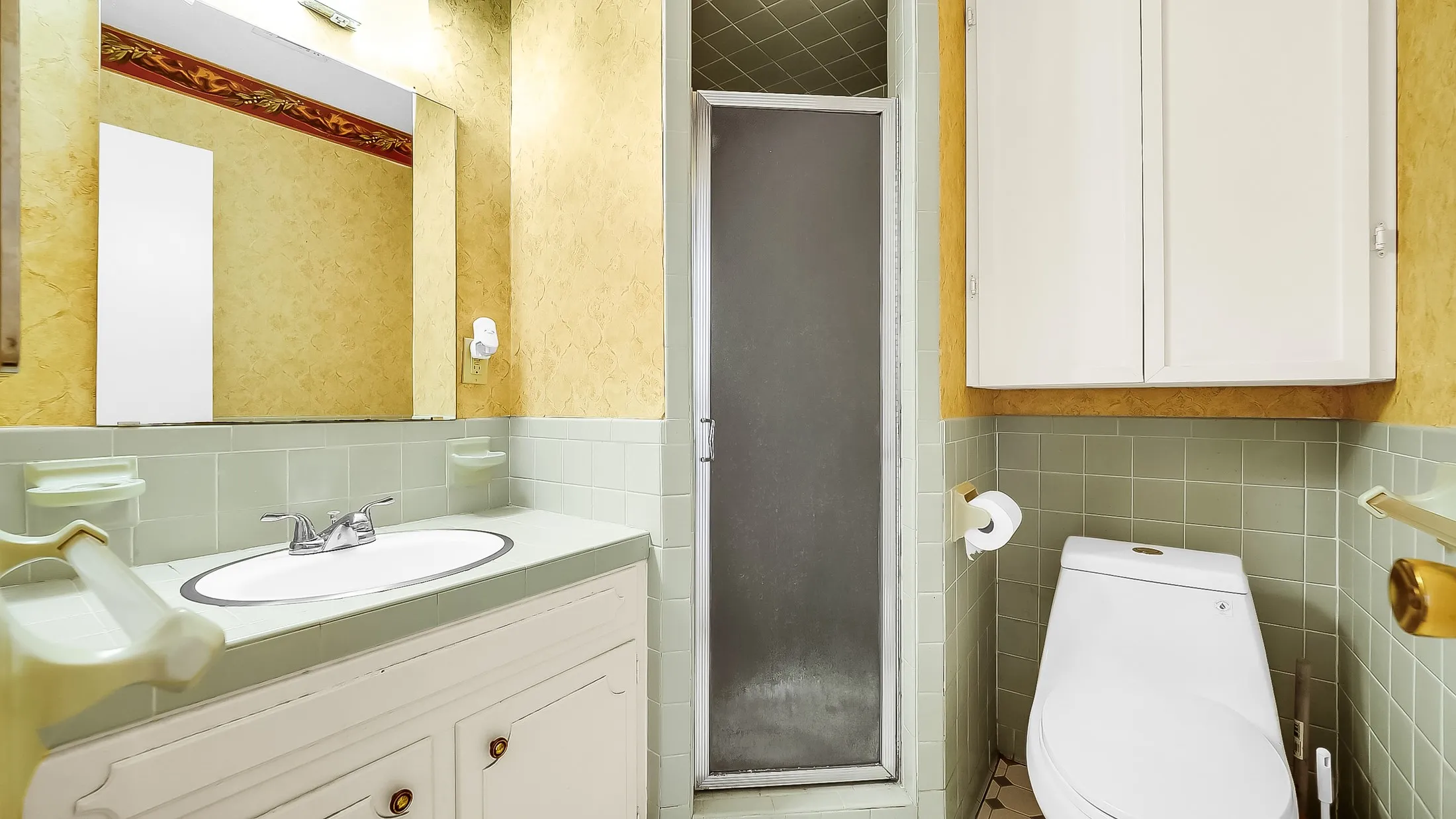 Bathroom featuring a vanity with an integrated sink, chrome faucet, and a wall-mounted mirror