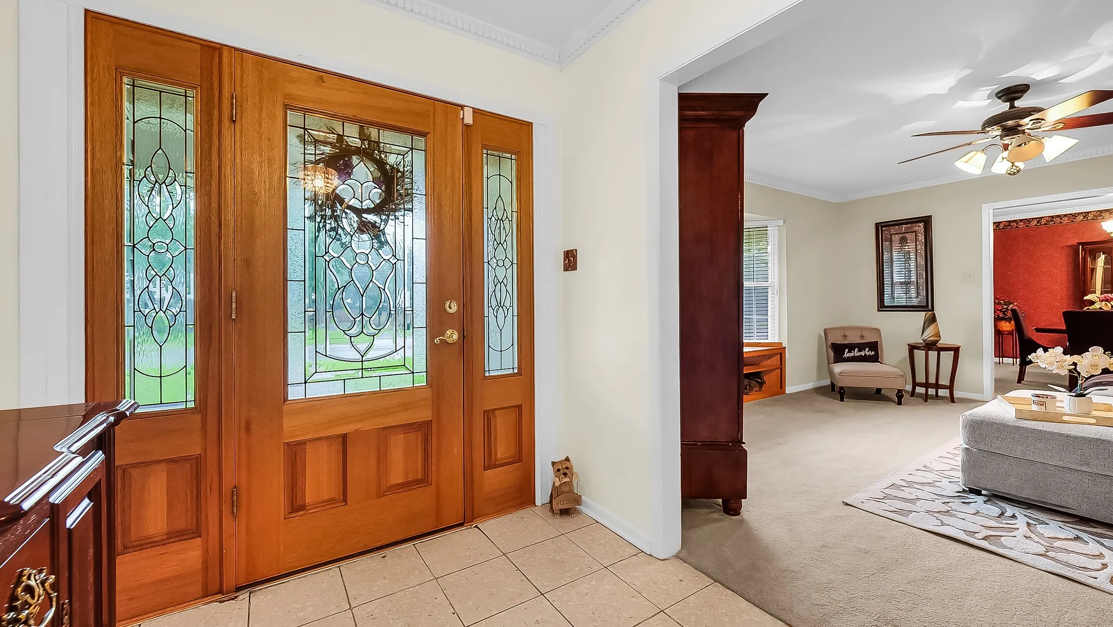 Entryway featuring a wood-finish double door with sidelights, leaded glass accents, and tile flooring