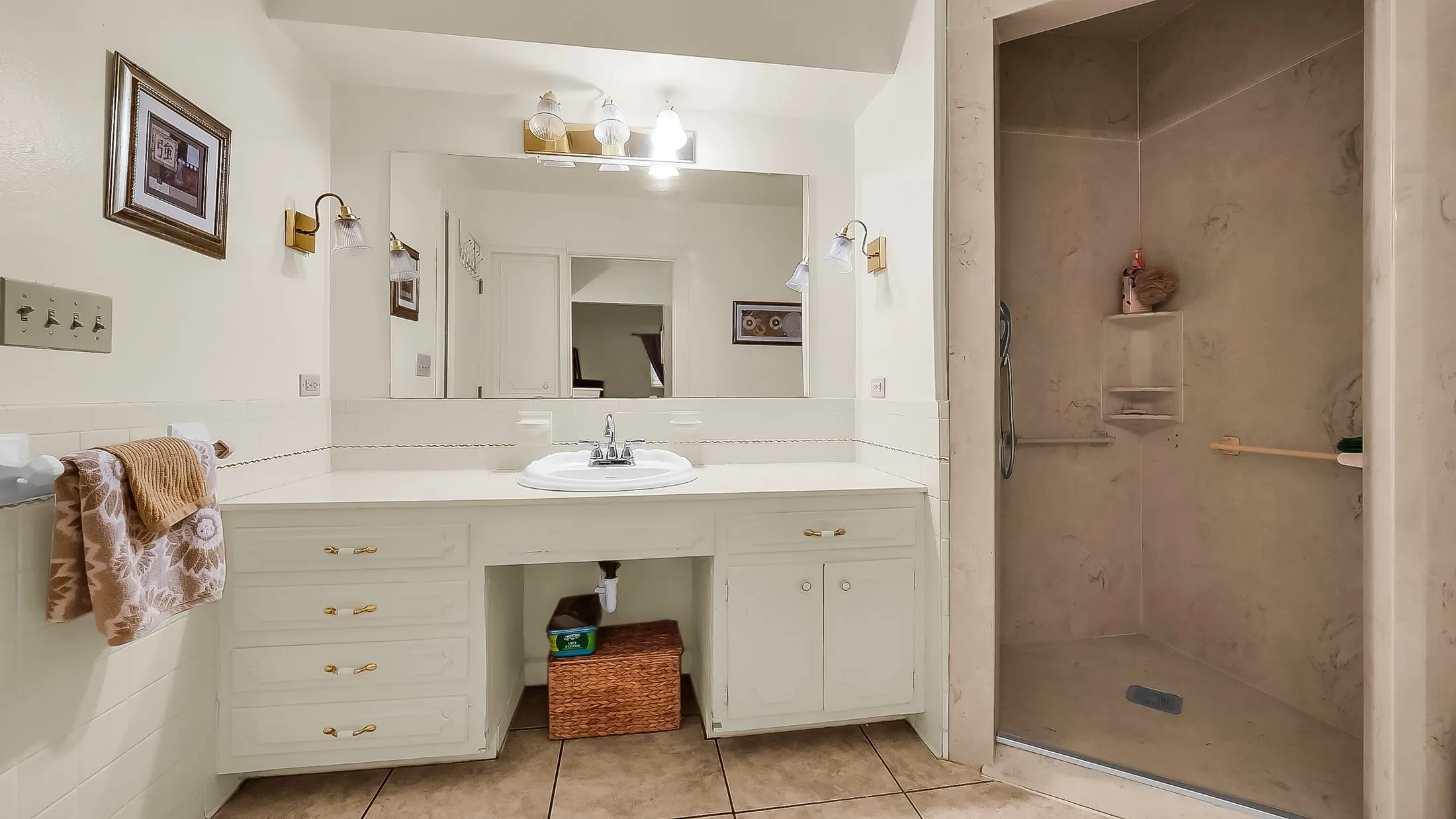 Bathroom vanity with an integrated sink, extended countertop space, and under-counter cabinetry