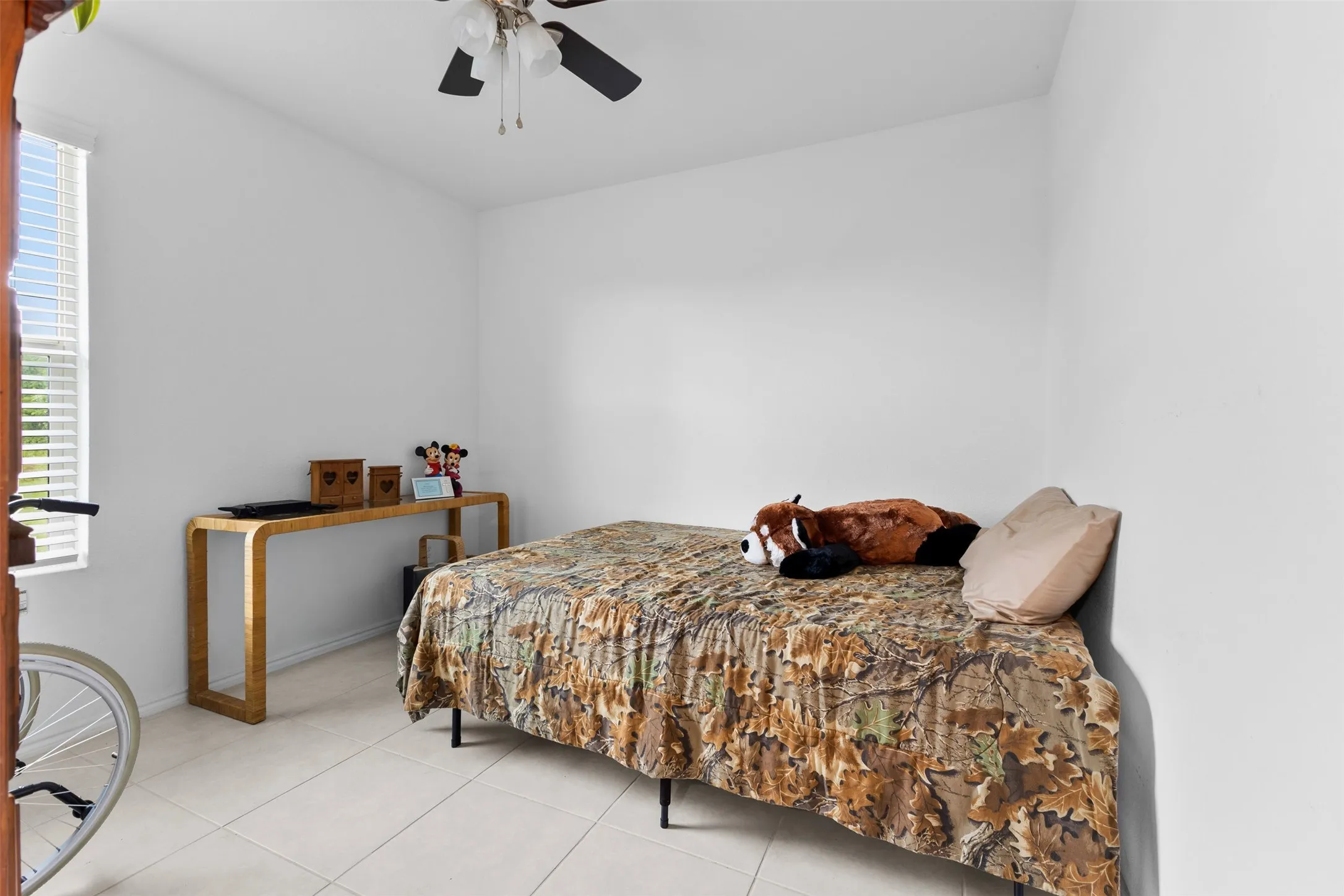 White walls and light-toned tile flooring create a bright interior