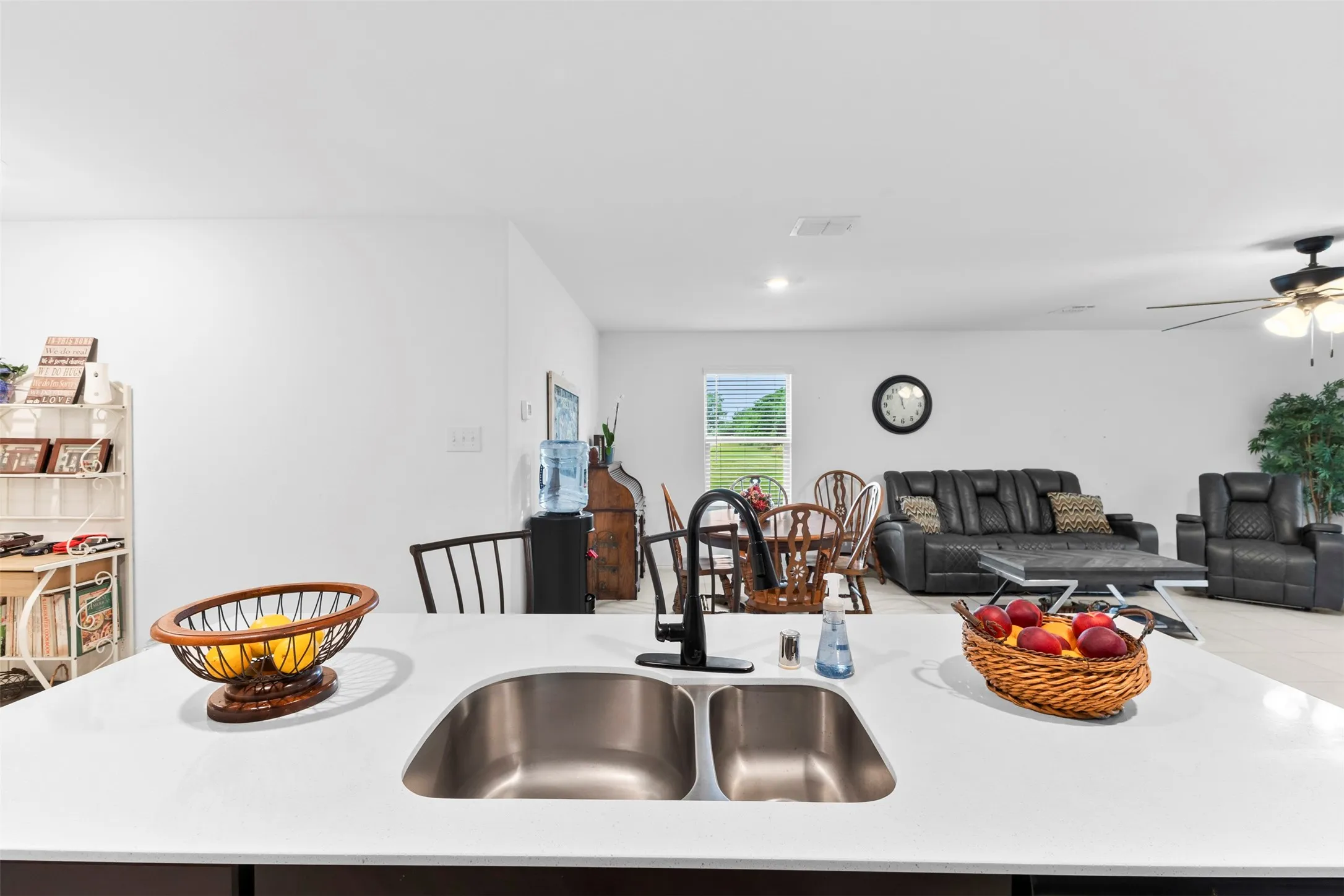 Kitchen island with a double stainless steel sink and matte black faucet