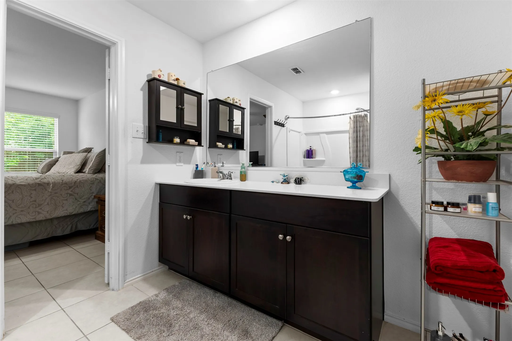 Double vanity with dark wood-finish cabinetry and white countertops
