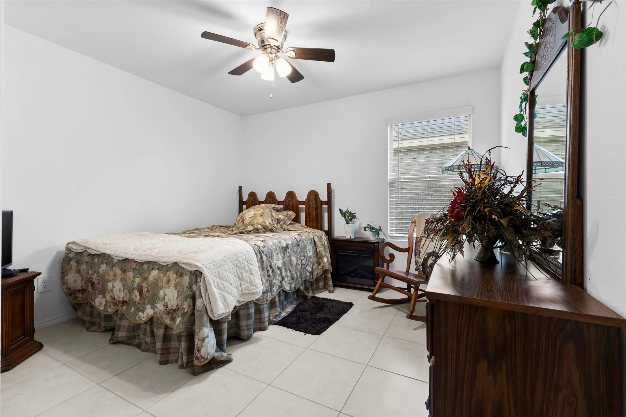 Bedroom featuring white walls and square tile flooring
