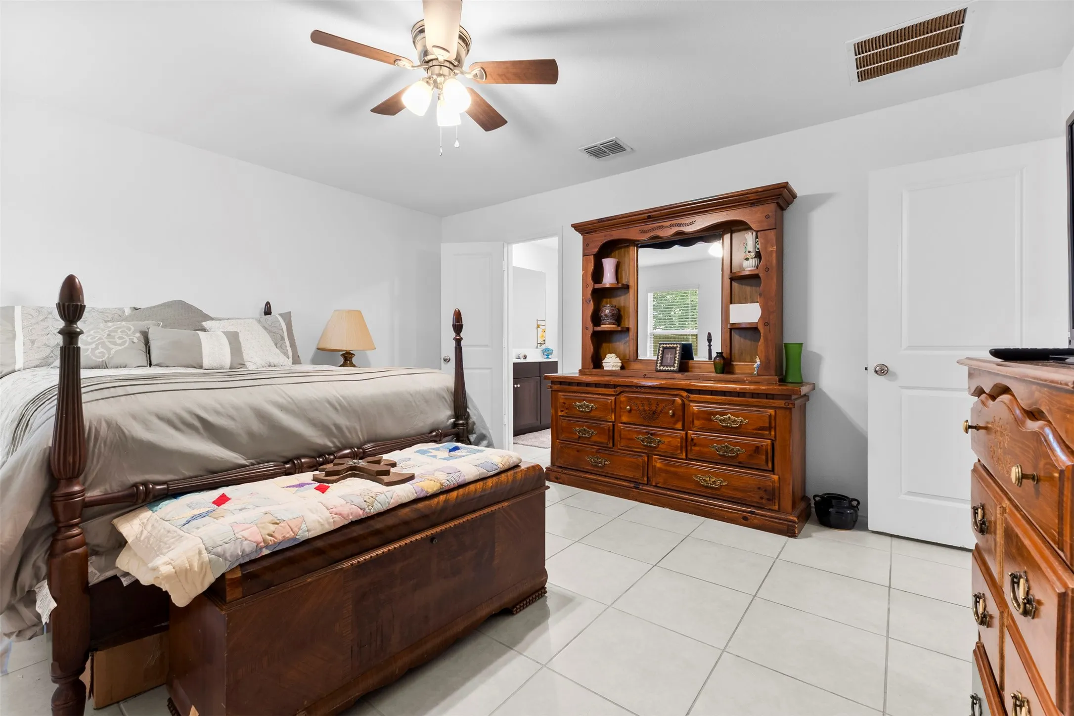 Bright room featuring tile flooring, white walls, and a ceiling fan