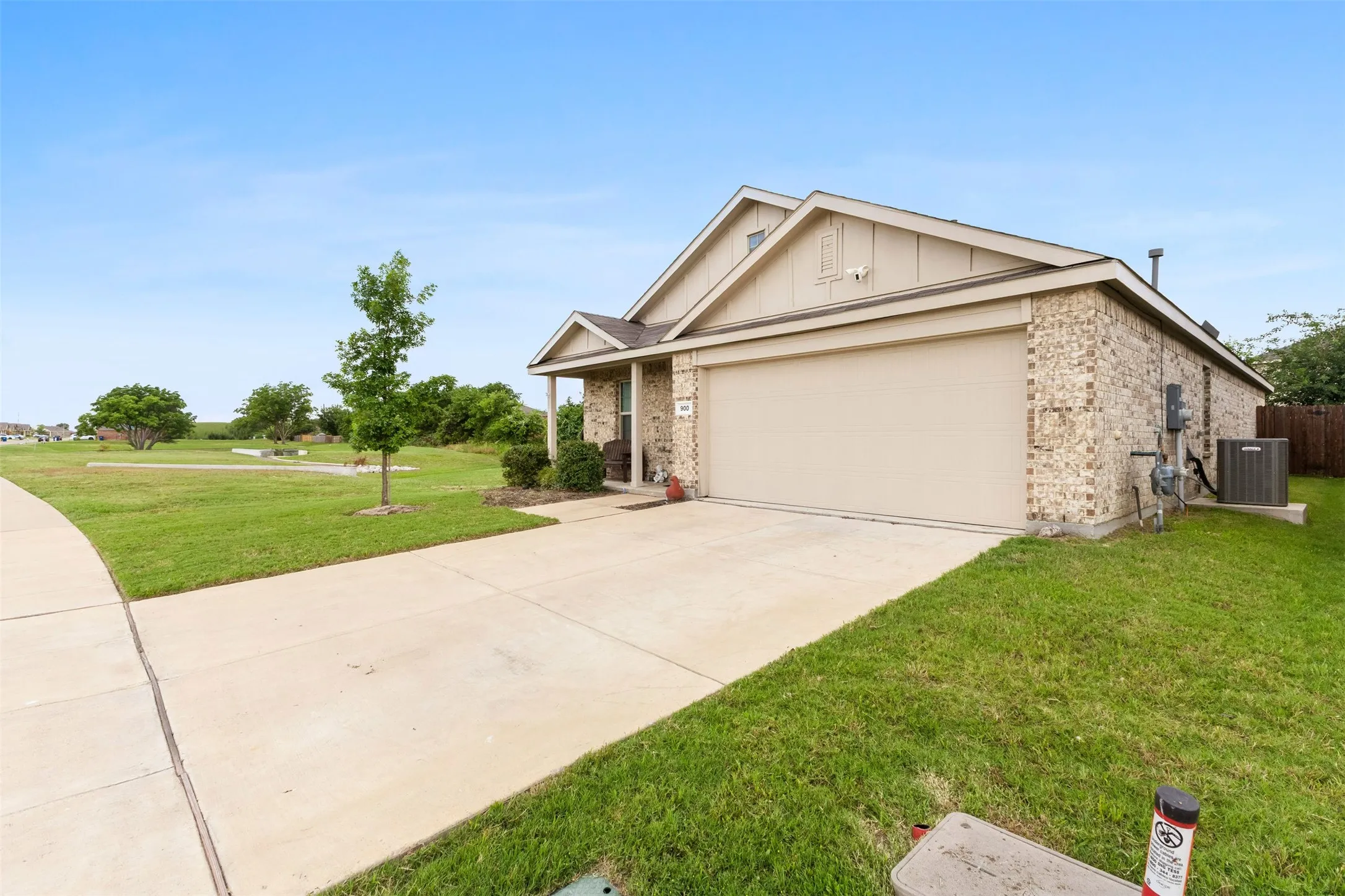 Single-story residence featuring a two-car garage, brick and siding exterior, and a concrete driveway