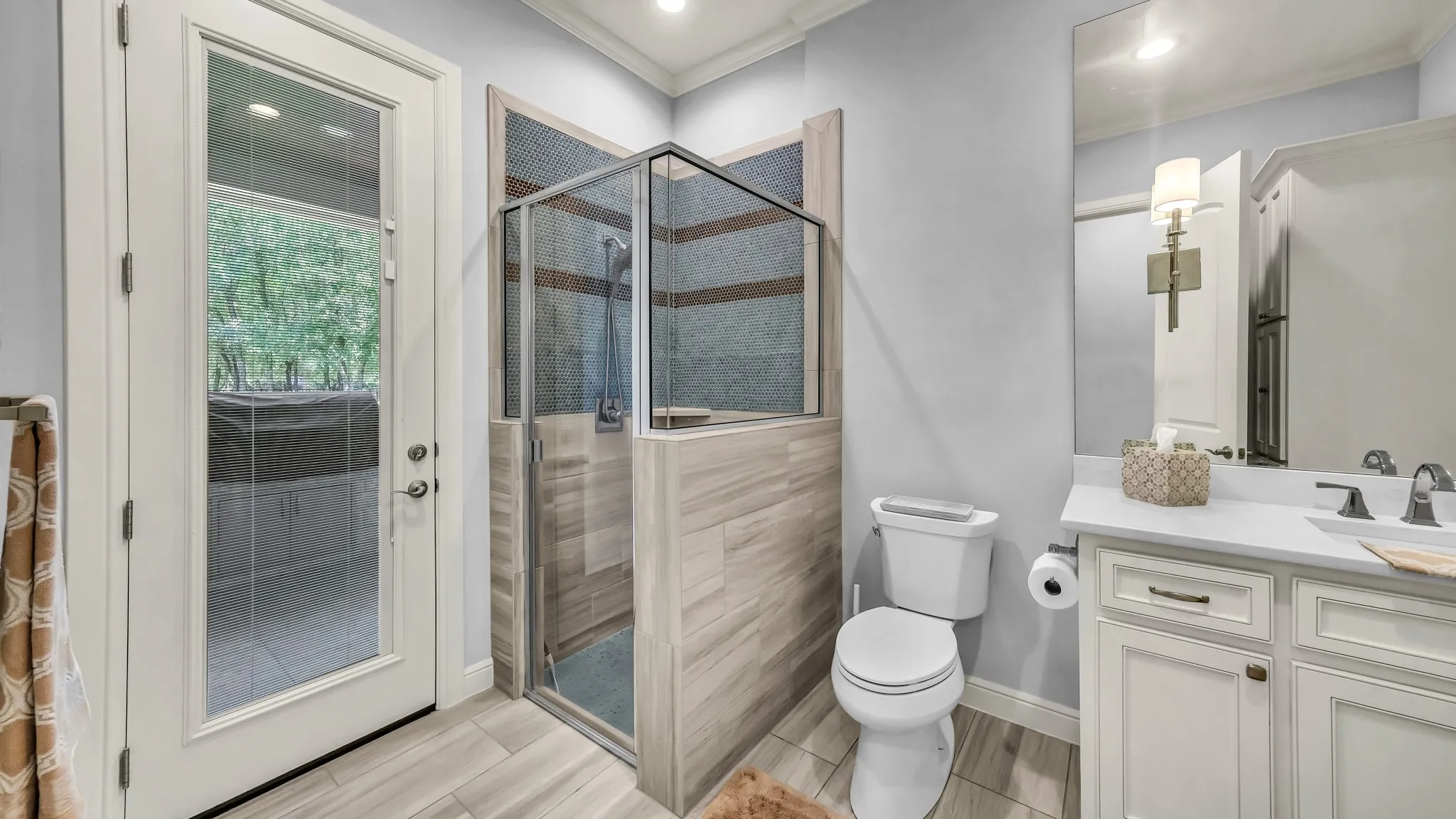 Ensuite for guest suite. This could also serve as a pool bath, should you decide to put a pool into the backyard. Walk-in shower. Leads to grill/dining porch. The door blinds can be adjusted for privacy.