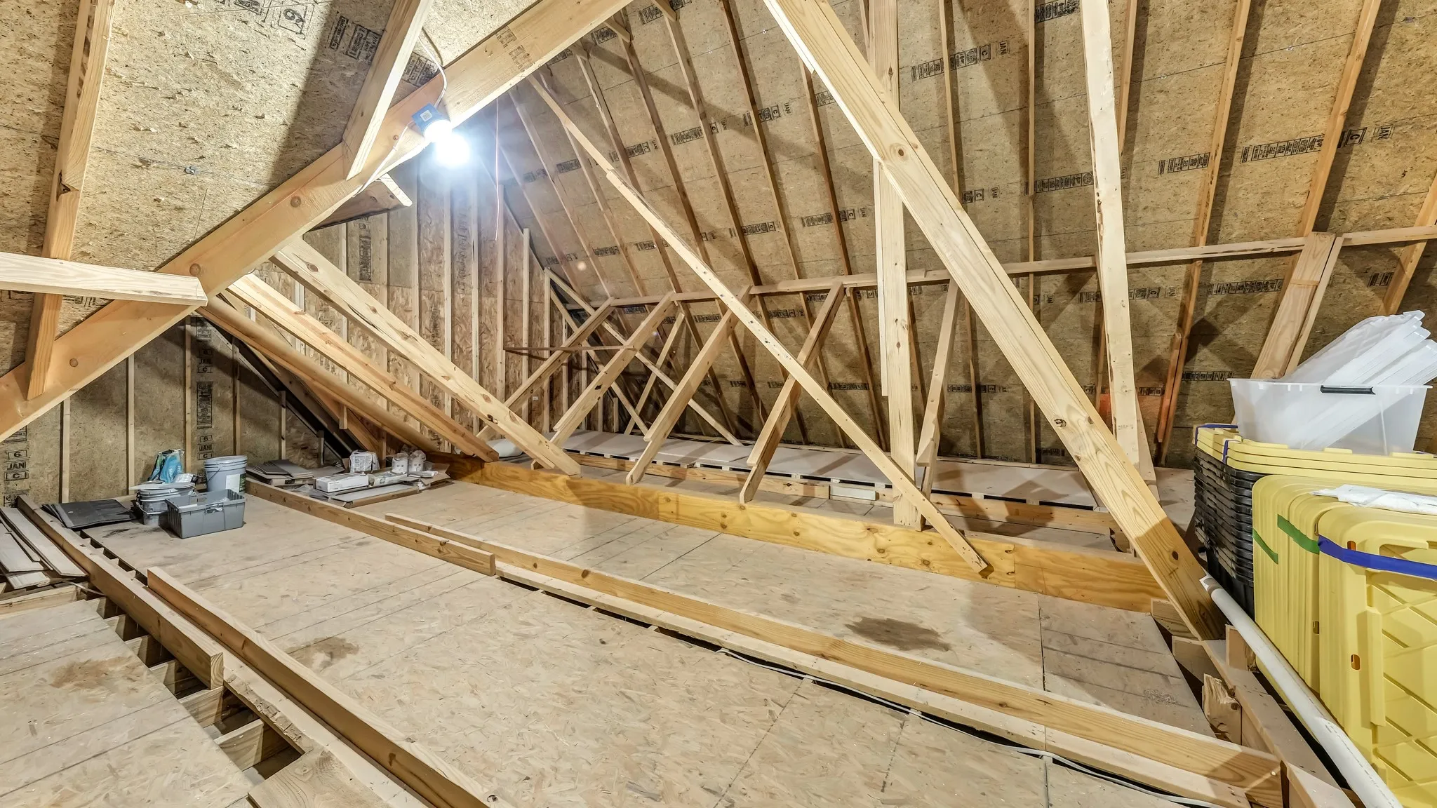 Walk up attic space. You can walk up a set of stairs located in the third car garage. At the top of the stairs is a ton of storage space, unconditioned. Open the door while there, to a conditioned attic area with foam insulation . You can use either the conditioned or unconditioned for storage.