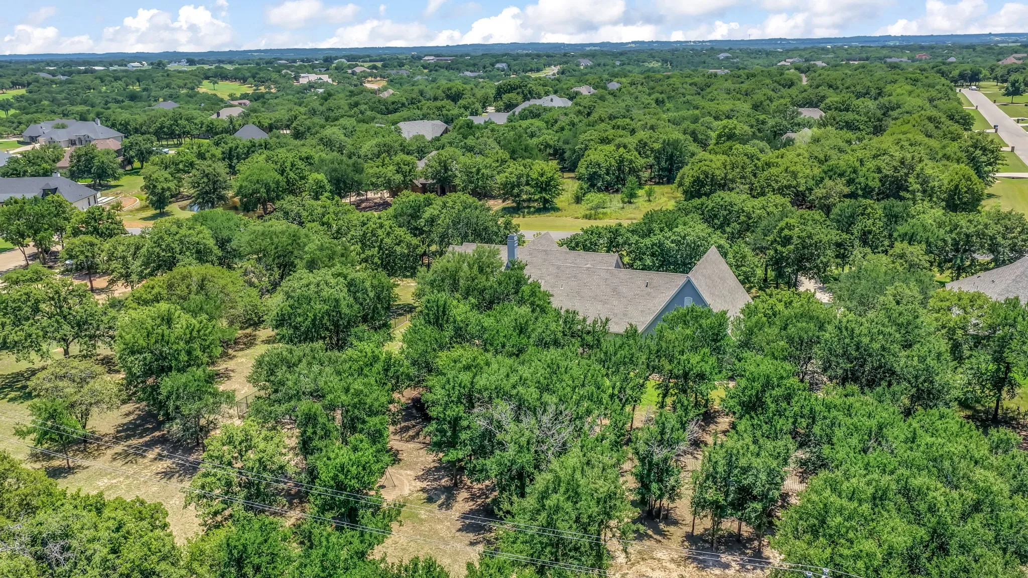 Overhead photo of home showing all of the trees on the property.