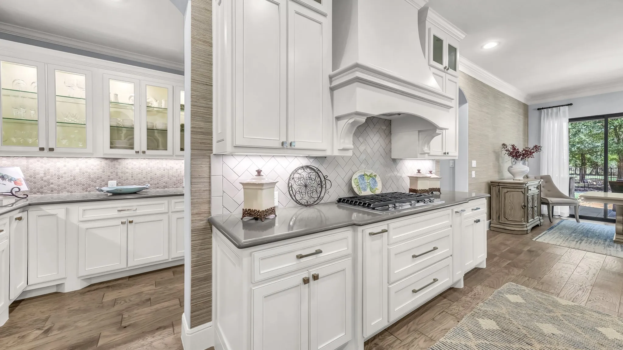 Better view of the butlers pantry. Lighted glass cabinetry, a plentitude of upper and lower cabinetry, and a built in ice machine. Vent hood is fabulous. Drawers on either side of the stove pull out as spice cabinets.