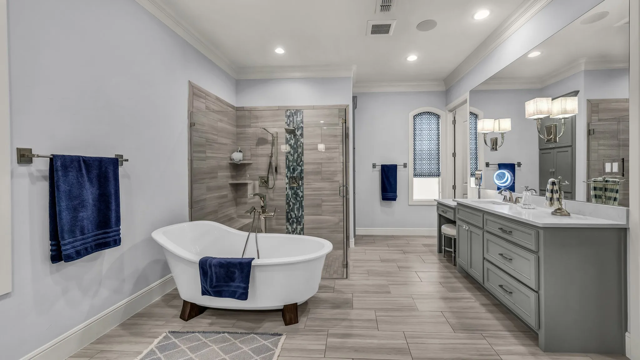 Partial view of the primary bathroom. Second closet is on the right, next to the window. Plenty of space for everyone's clothes.