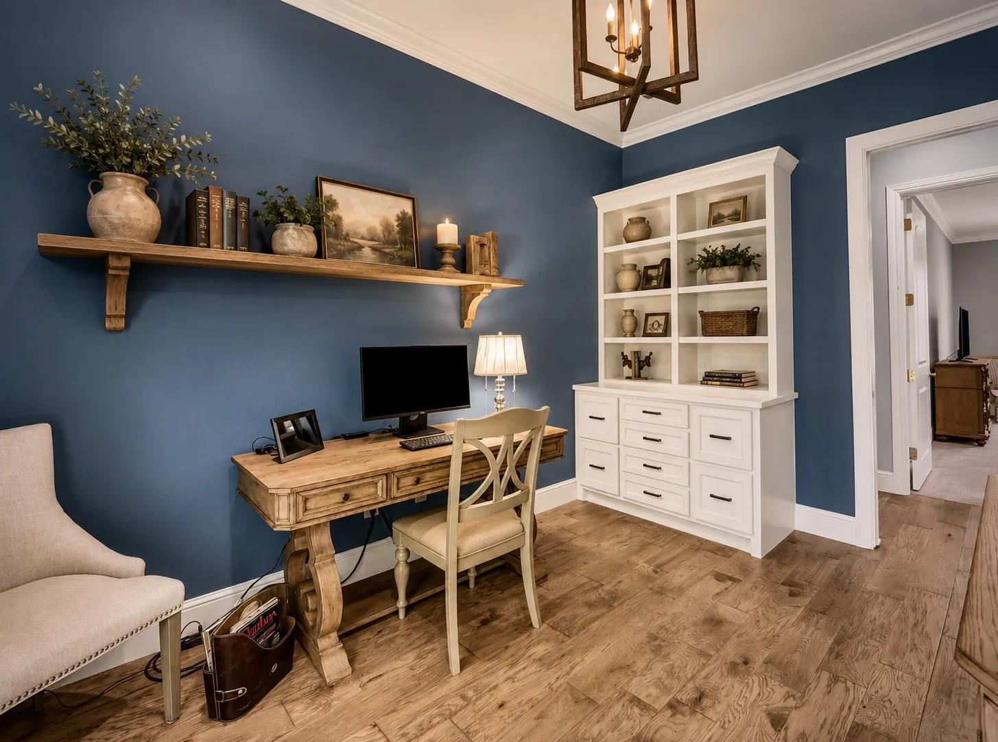Warm office with built in shelve and drawers. Pocket door at office door. AI added shelf above desk.