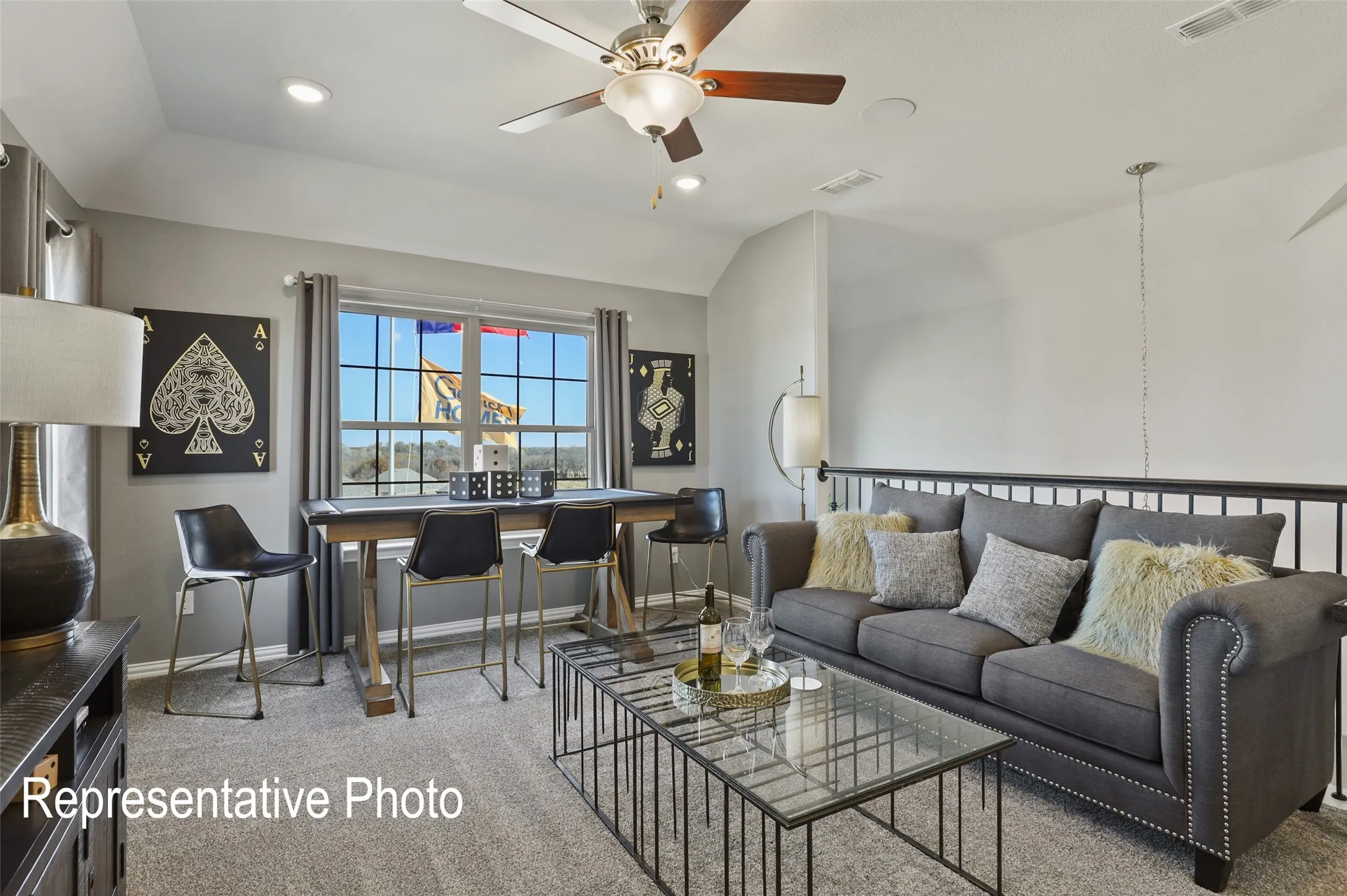 Spacious loft area featuring light gray walls, plush carpeting, a multi-pane window, a ceiling fan with integrated lighting, and recessed lighting