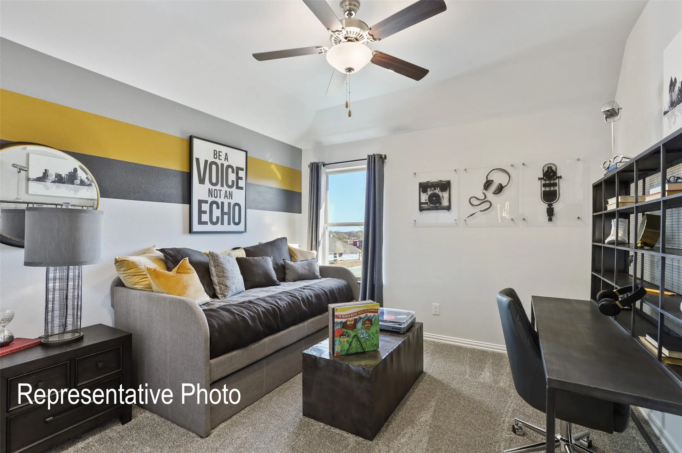 Room featuring vaulted ceiling with a ceiling fan, a window with dark drapes, and carpet flooring