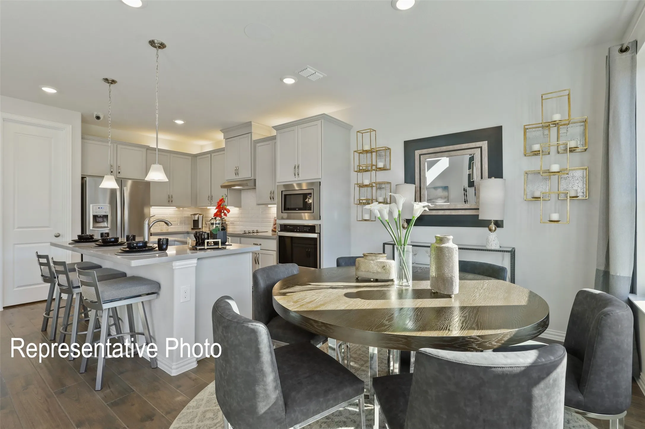 Open-concept kitchen and dining area with wood-finish flooring