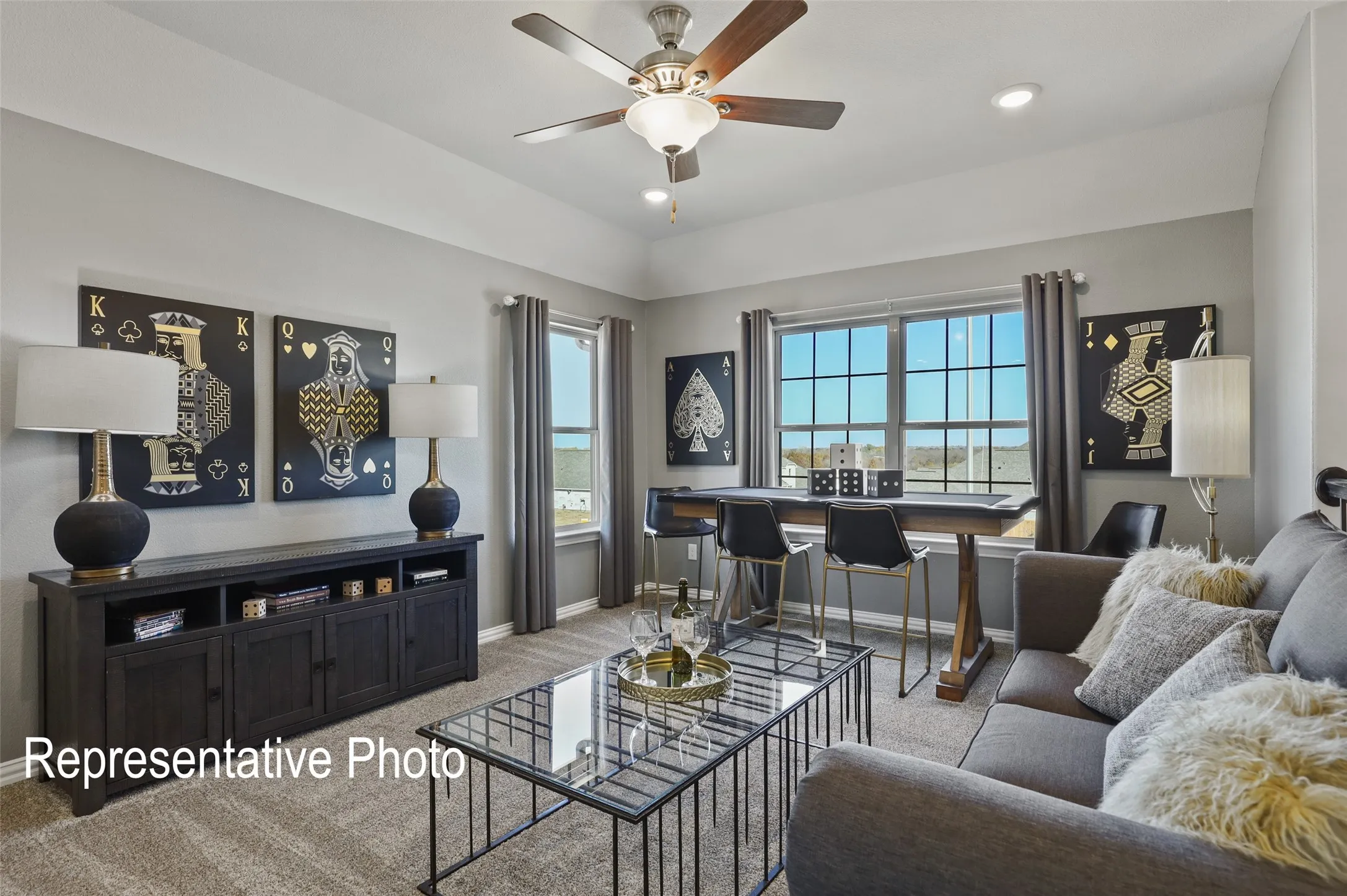 Spacious room with a tray ceiling, recessed lighting, and a ceiling fan