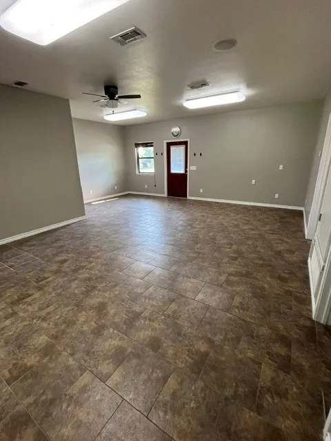 large room after with dining area and small desk or entry area
