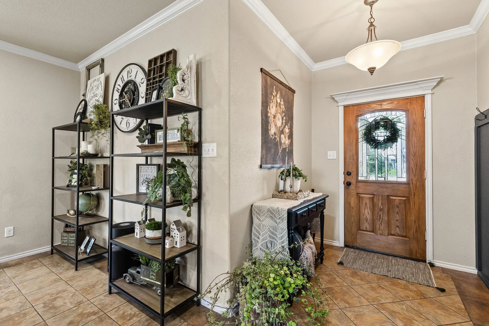 Entryway featuring a wood-panel door with decorative glass inserts, recessed lighting, crown molding, and tile flooring