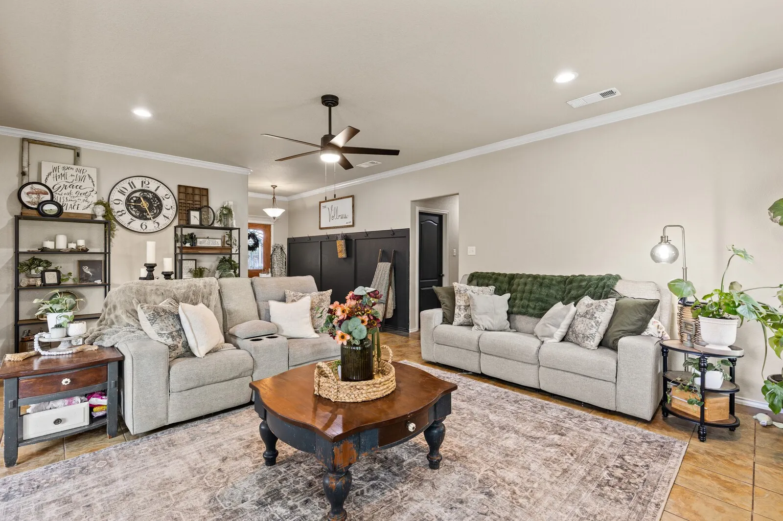 Spacious living area featuring neutral wall tones, recessed lighting, and a ceiling fan