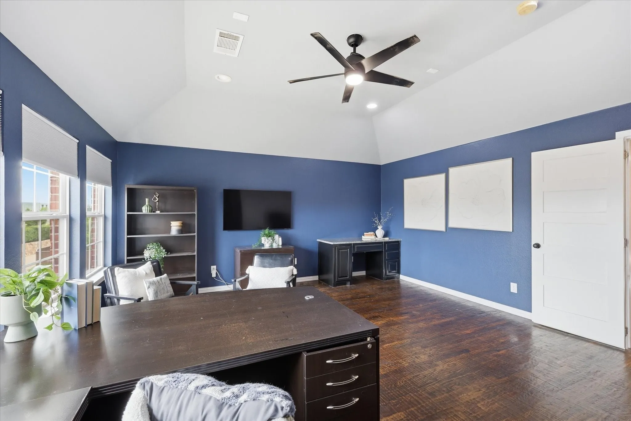 2253 Big Valley Circle, Allen, TX 75013 - office/media/ game room - Spacious room featuring vaulted ceilings, dark wood-finish flooring, multiple windows with roller shades, and a ceiling fan with integrated lighting