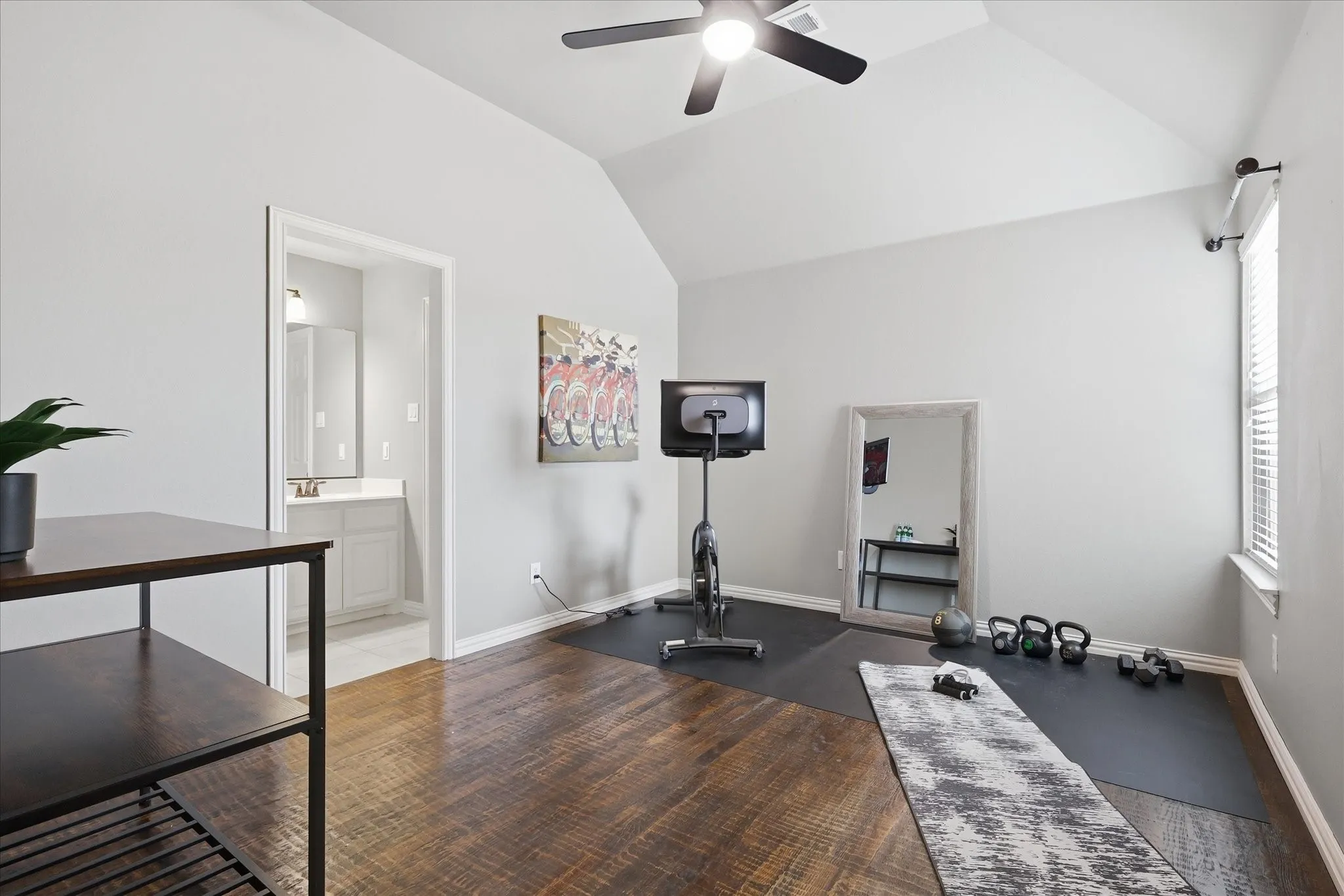 2253 Big Valley Circle, Allen, TX 75013 - bedroom - Spacious bedroom featuring vaulted ceilings, dark wood-finish flooring, and a ceiling fan with integrated lighting