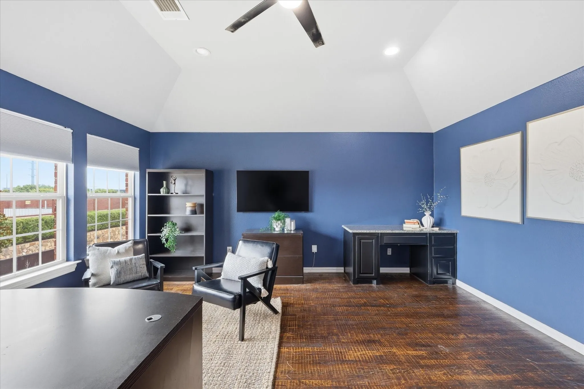 2253 Big Valley Circle, Allen, TX 75013 - office/media/ game room - Spacious room featuring vaulted ceilings, dark wood-finish flooring, multiple windows with roller shades, and a ceiling fan with integrated lighting