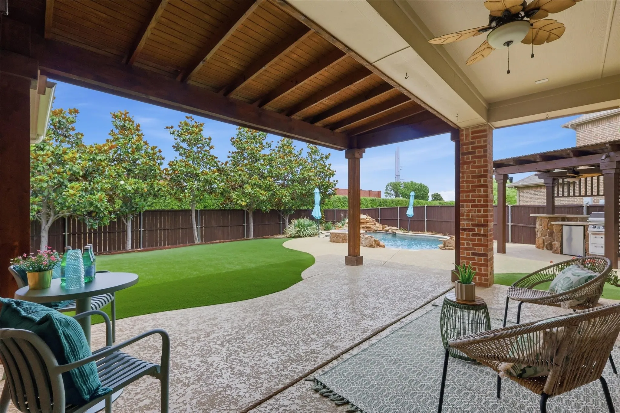 2253 Big Valley Circle, Allen, TX 75013 - Patio - Covered patio with a wood-plank ceiling and a ceiling fan, offering a patterned concrete surface