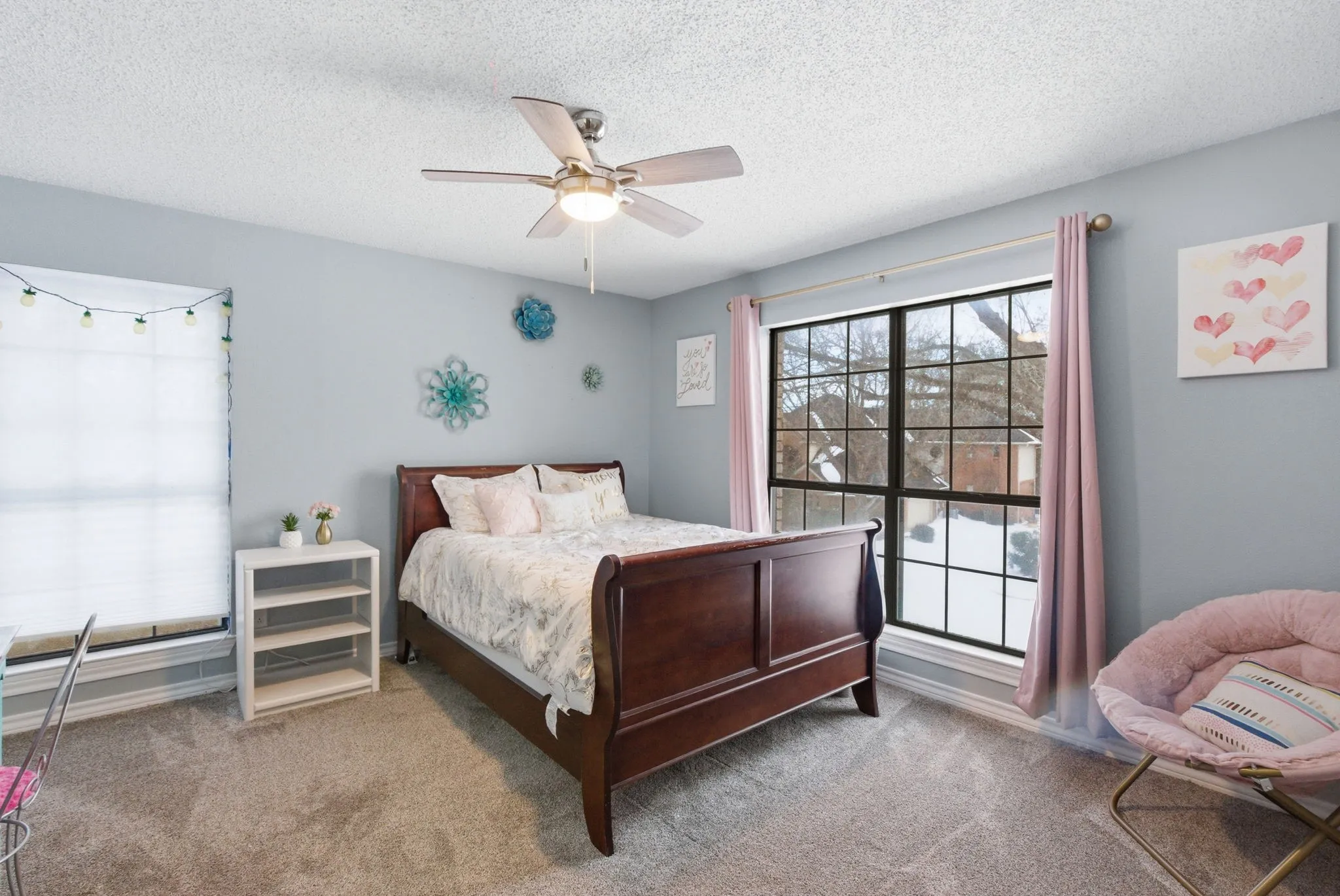 Carpeted room featuring light gray walls and a ceiling fan