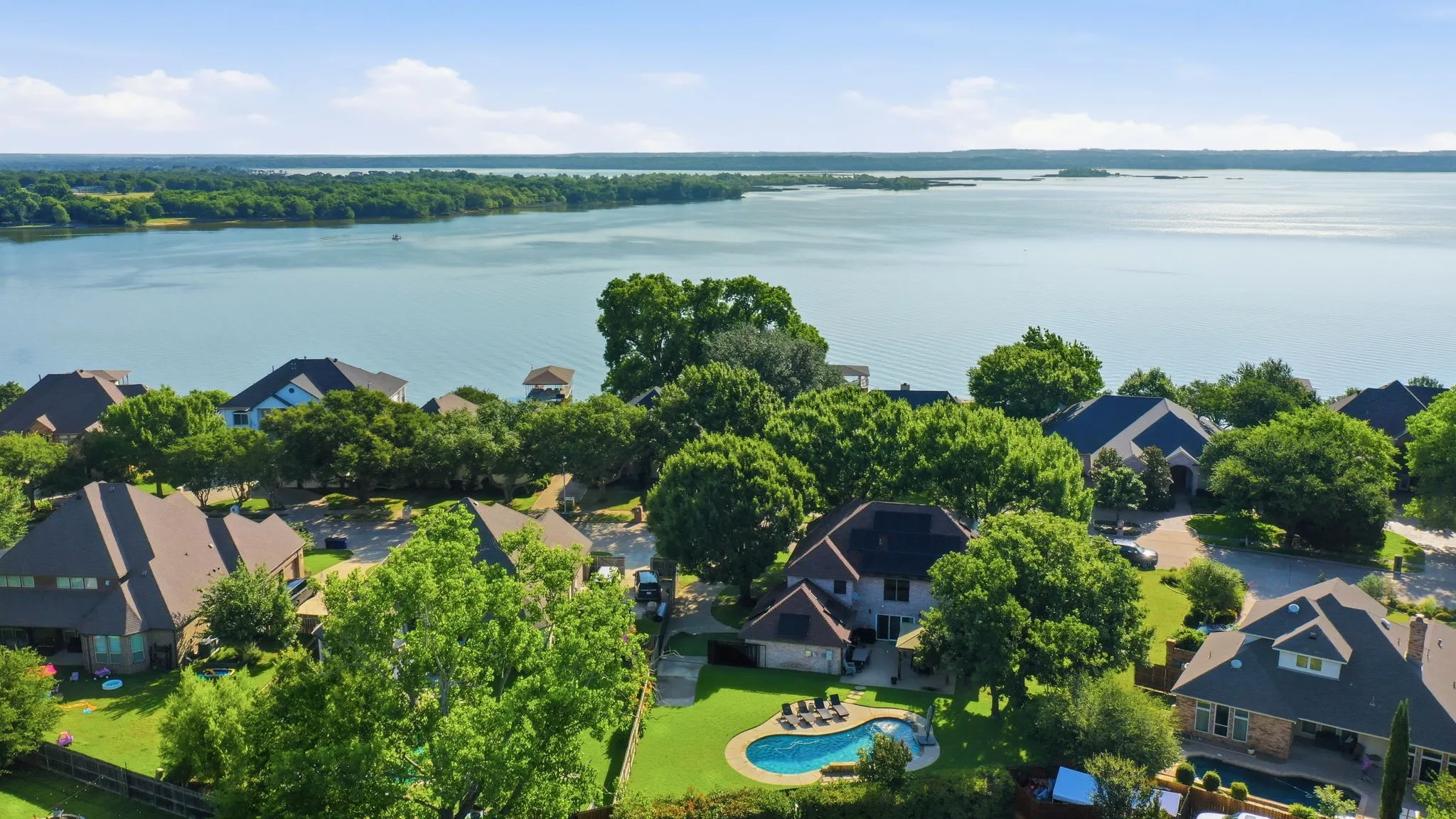 Aerial perspective showcasing a residential area with lake access