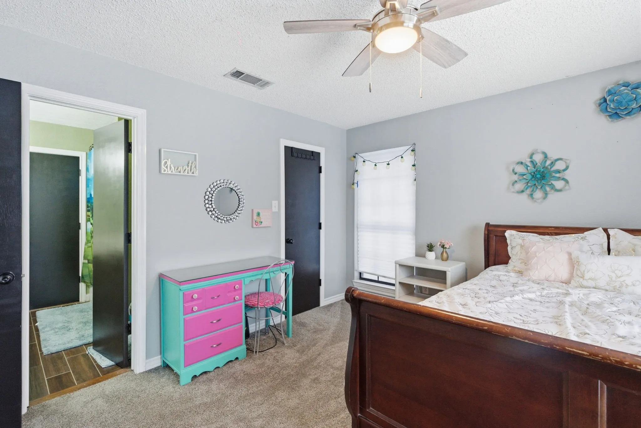 Carpeted room with light gray walls and a ceiling fan with integrated lighting