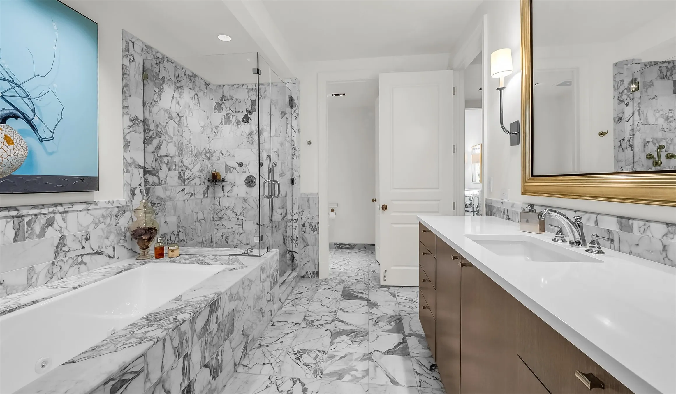 Beautifully Appointed His and Her Primary Marbel Bathrooms.