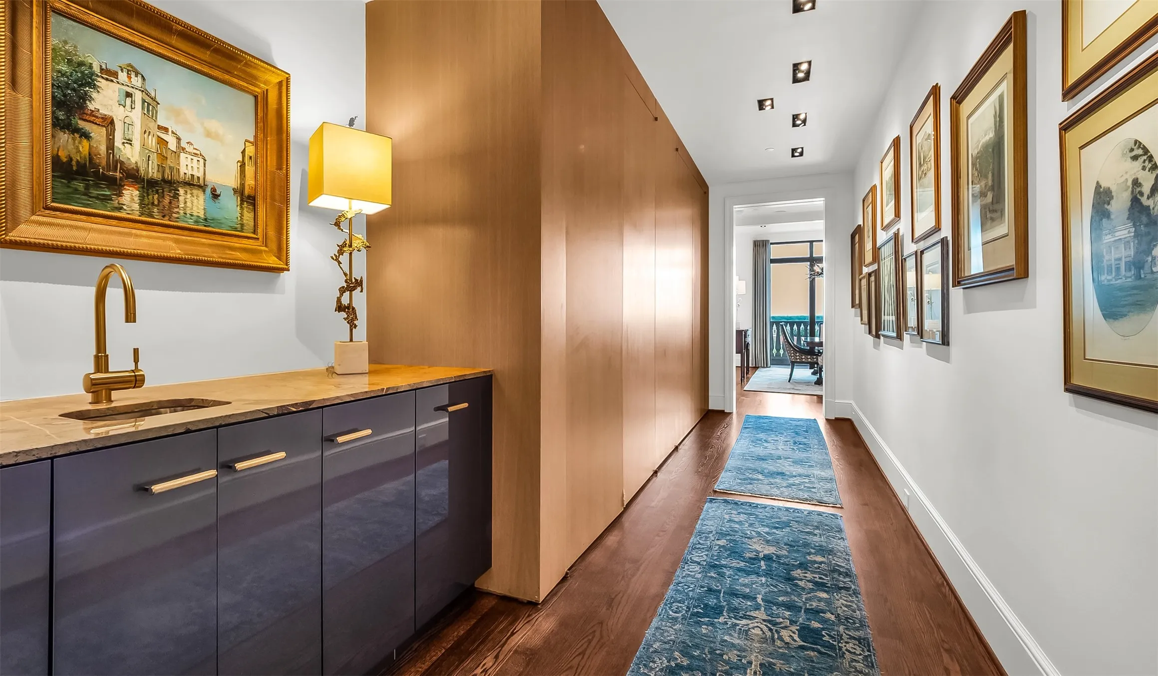 Wet Bar & Gallery Leads From Foyer To Kitchen, Dining Room, & Second Bedroom & Utility Room.