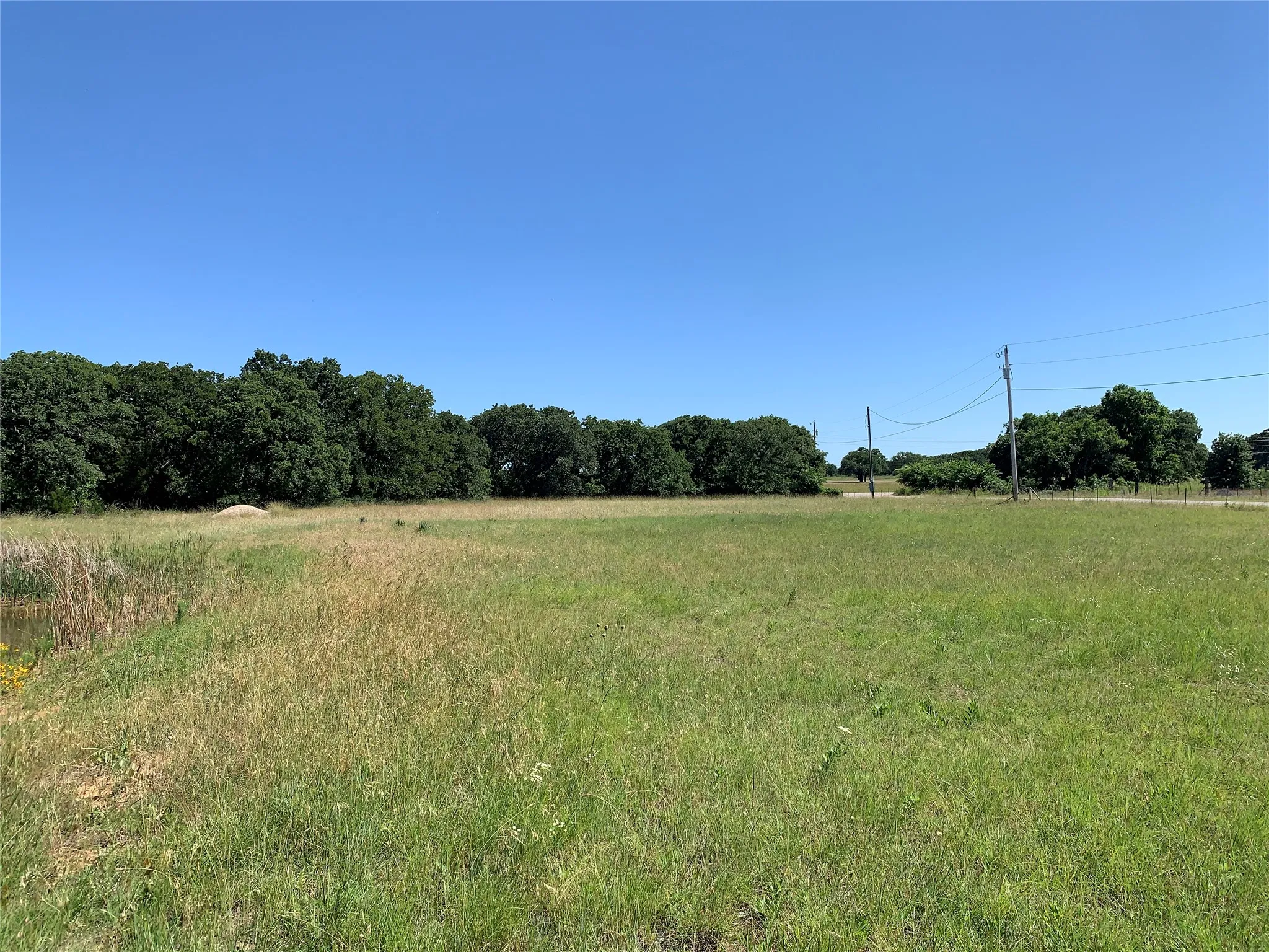Lot is on corner with one road heavily treed and the other open with view of Golf Course.