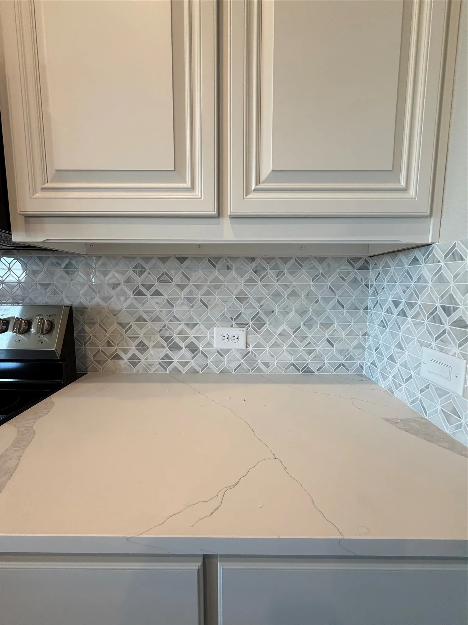 Marcella quartz counters and decorative mosaic tile backsplash to tie it all together