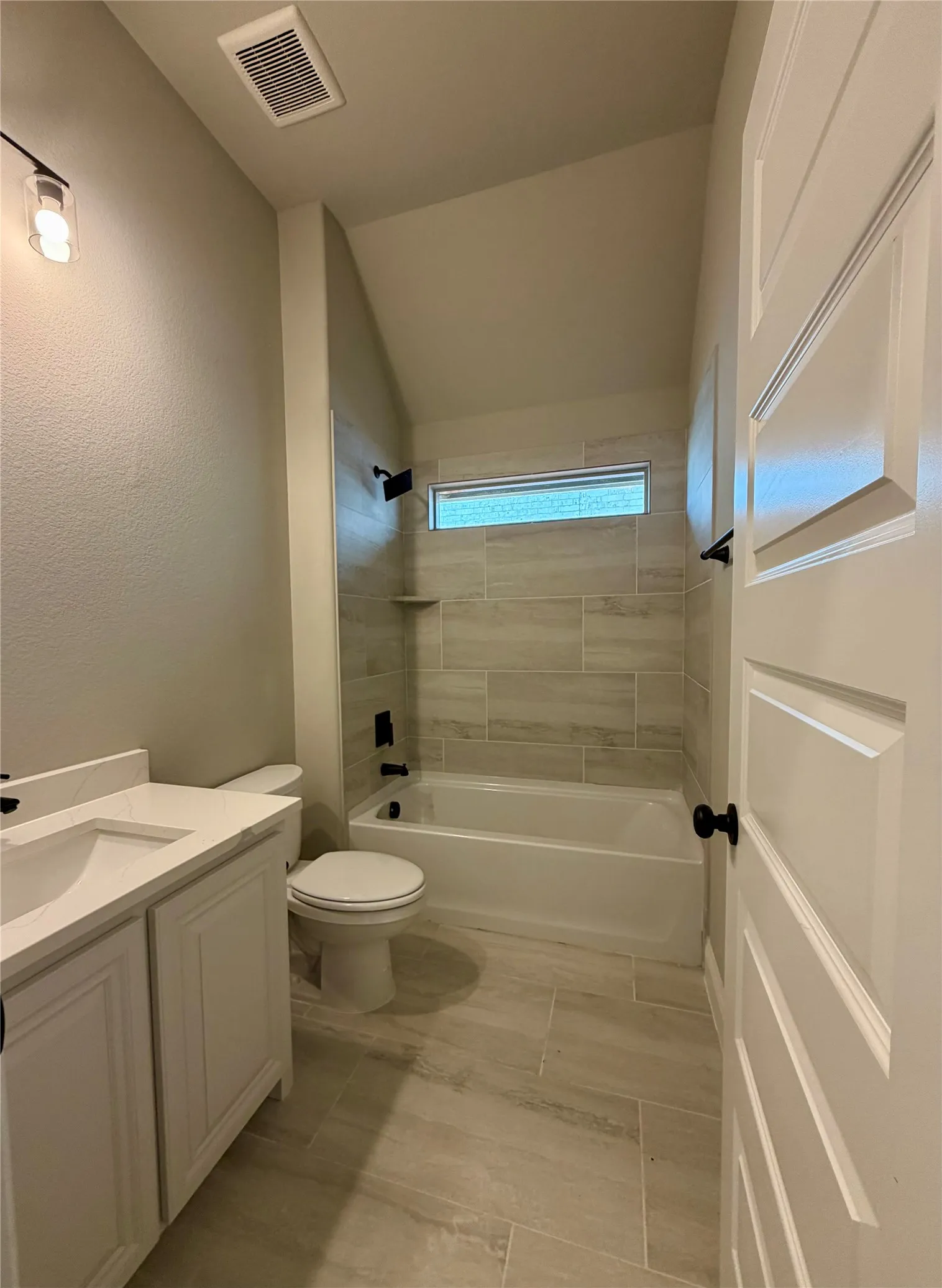 Bath 2 offers 12x24 tile, quartz counters & window for natural light