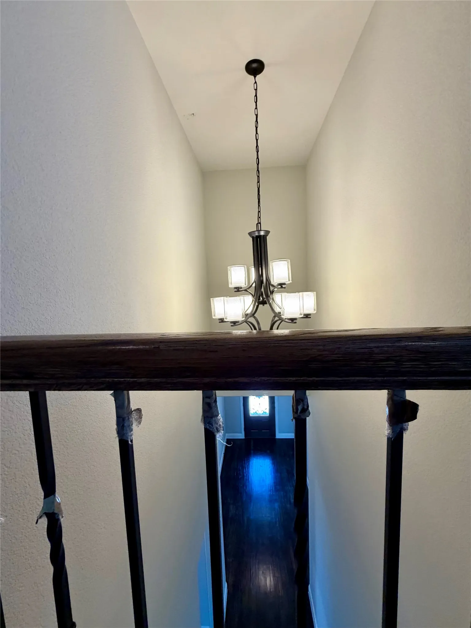 View of custom chandelier from gameroom to entry