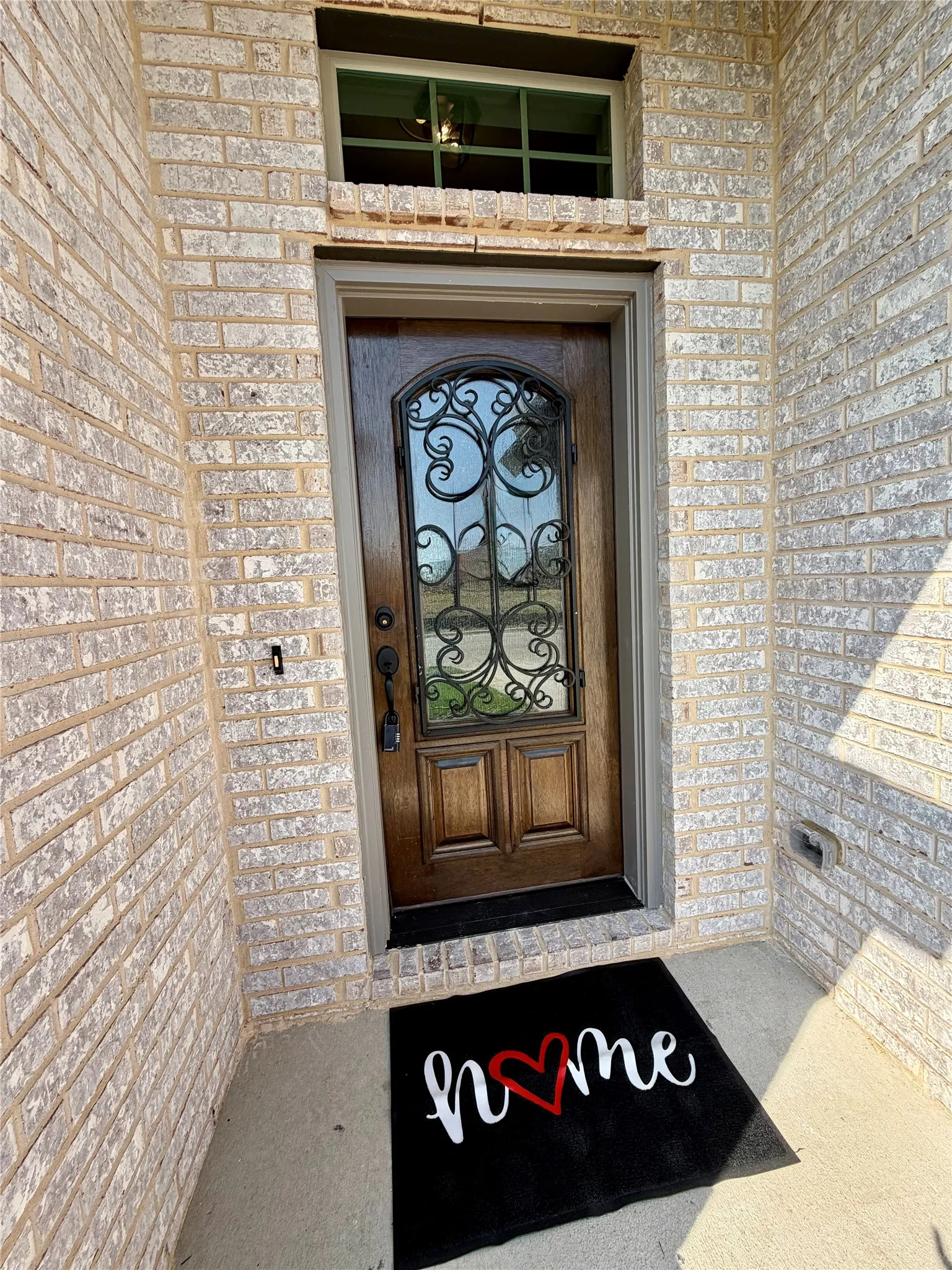 Elegant first impression with iron & glass mahogany front door.