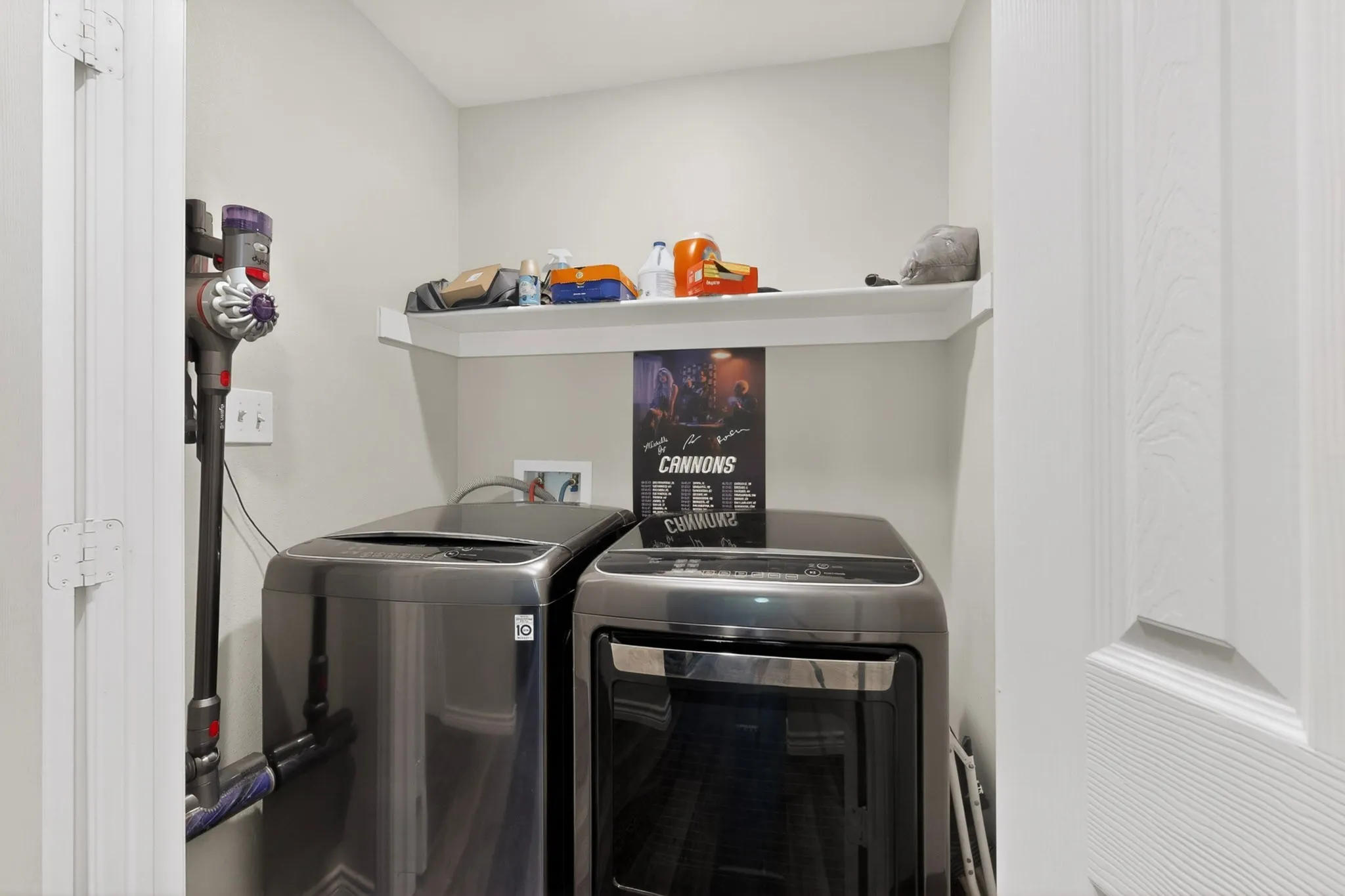 Dedicated utility space featuring light neutral wall paint and white trim