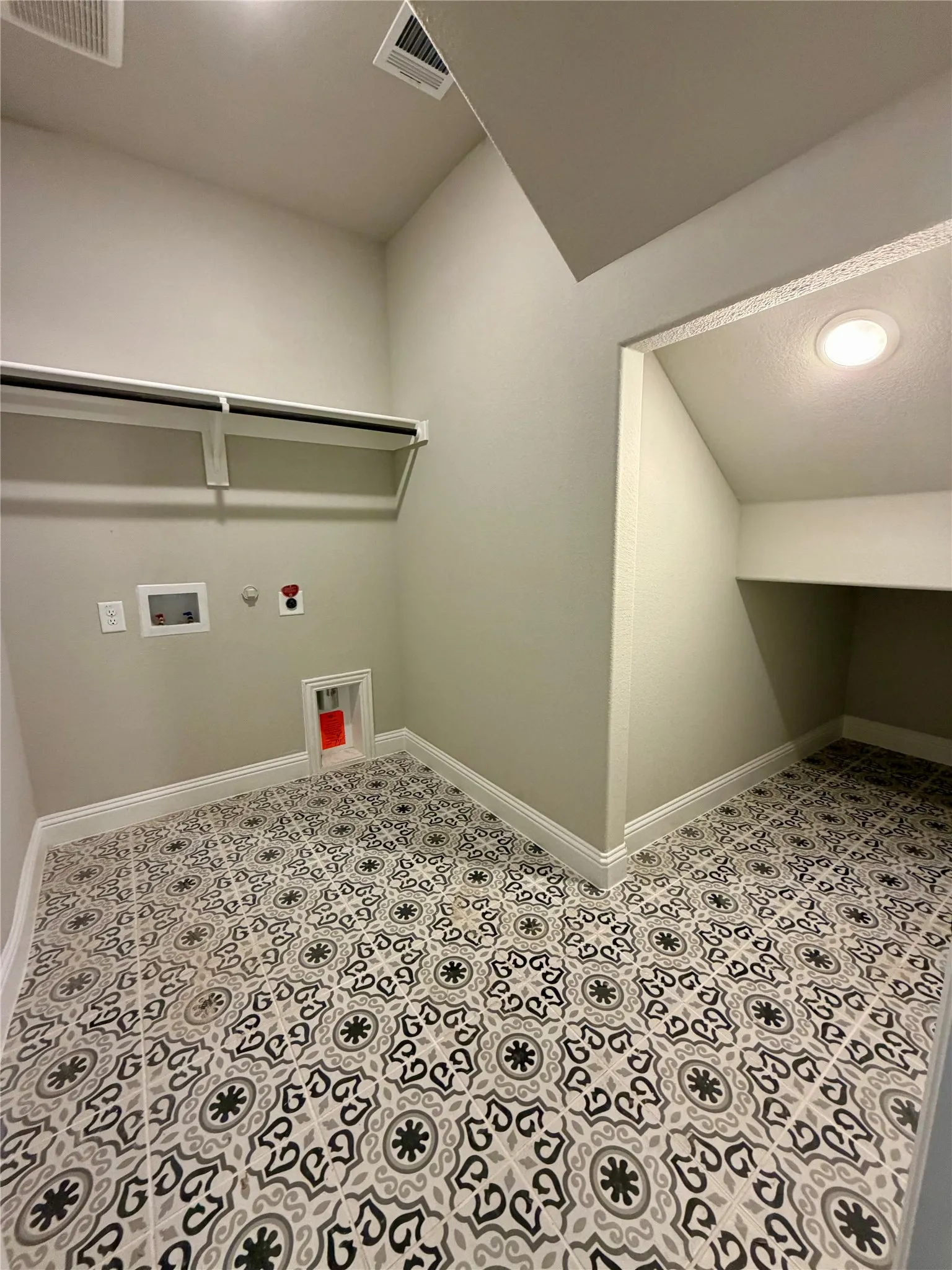 Fun decorative tile and extra storage under the stairs