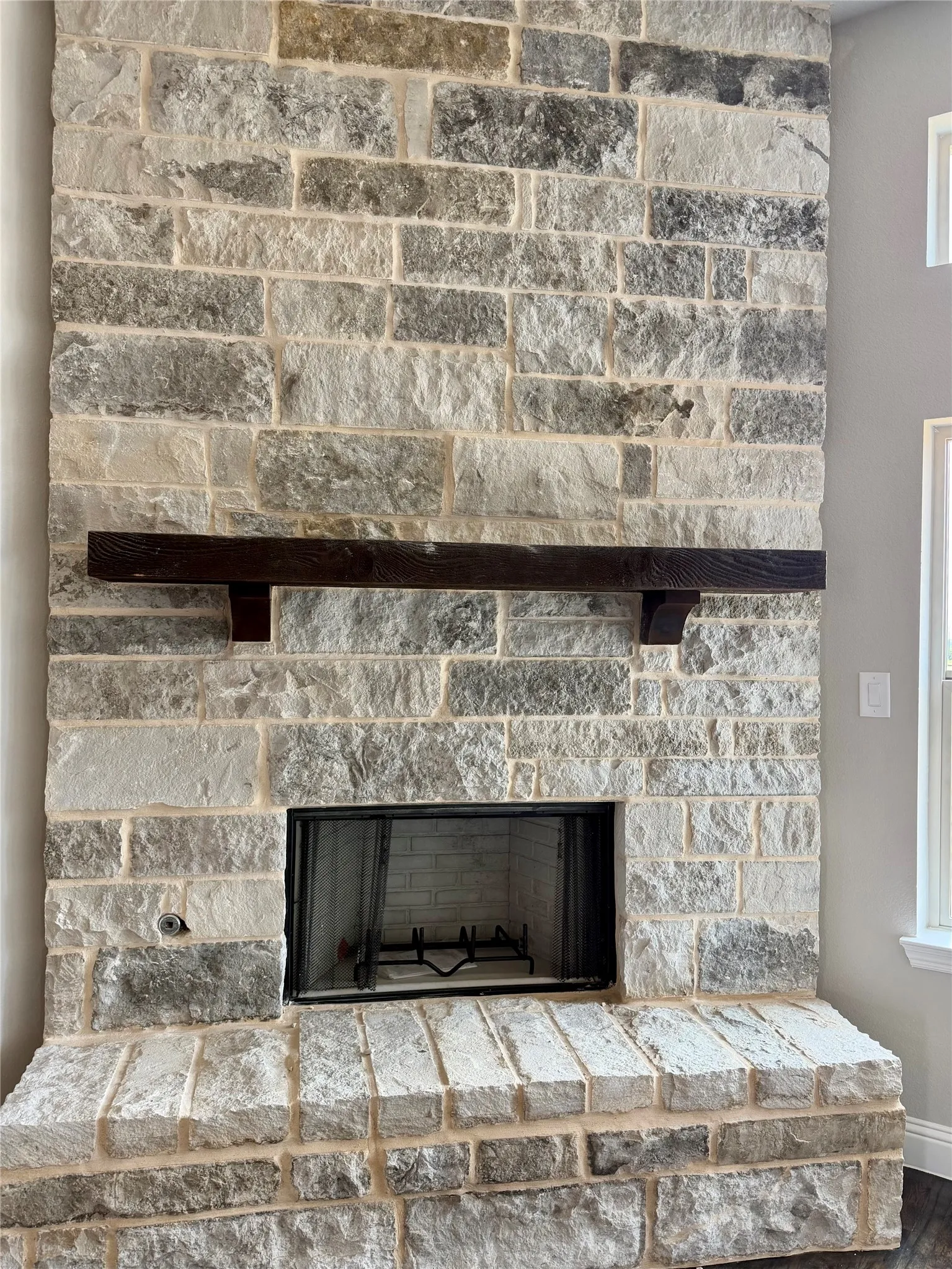 Stunning Blue Marble Stone fireplace with gas or wood burning and cedar mantle